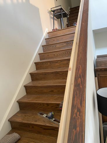 A set of wooden stairs leading up to the second floor of a house.