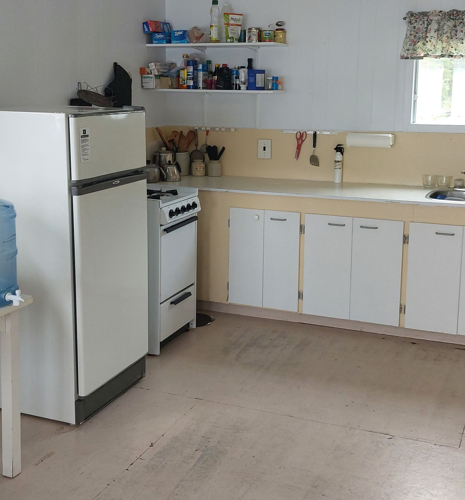 A kitchen with a stove and a refrigerator with the number 4 on it