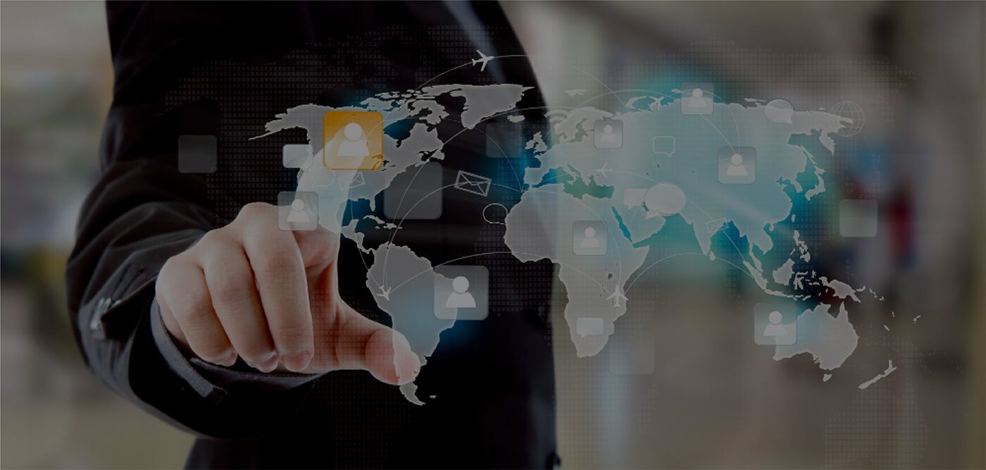 Person's finger touching a digital world map, concept of global connectivity and technology.