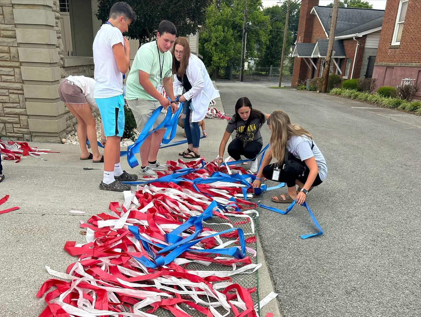 Center participants working on red, white, and blue decorations.