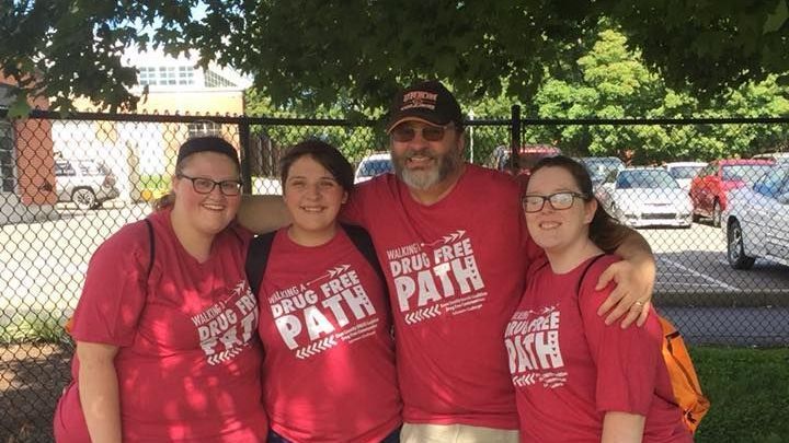 Miller and students wearing red t-shirts that read Walking A Drug Free Path.