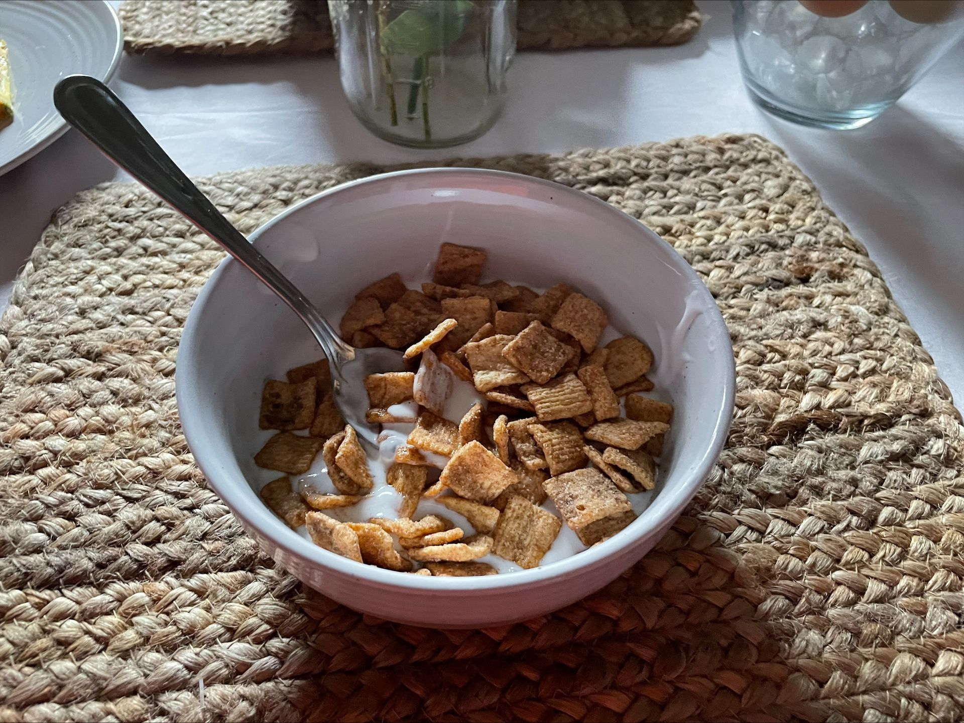 A bowl of cereal mixed with glue instead of milk sits on a woven tray.