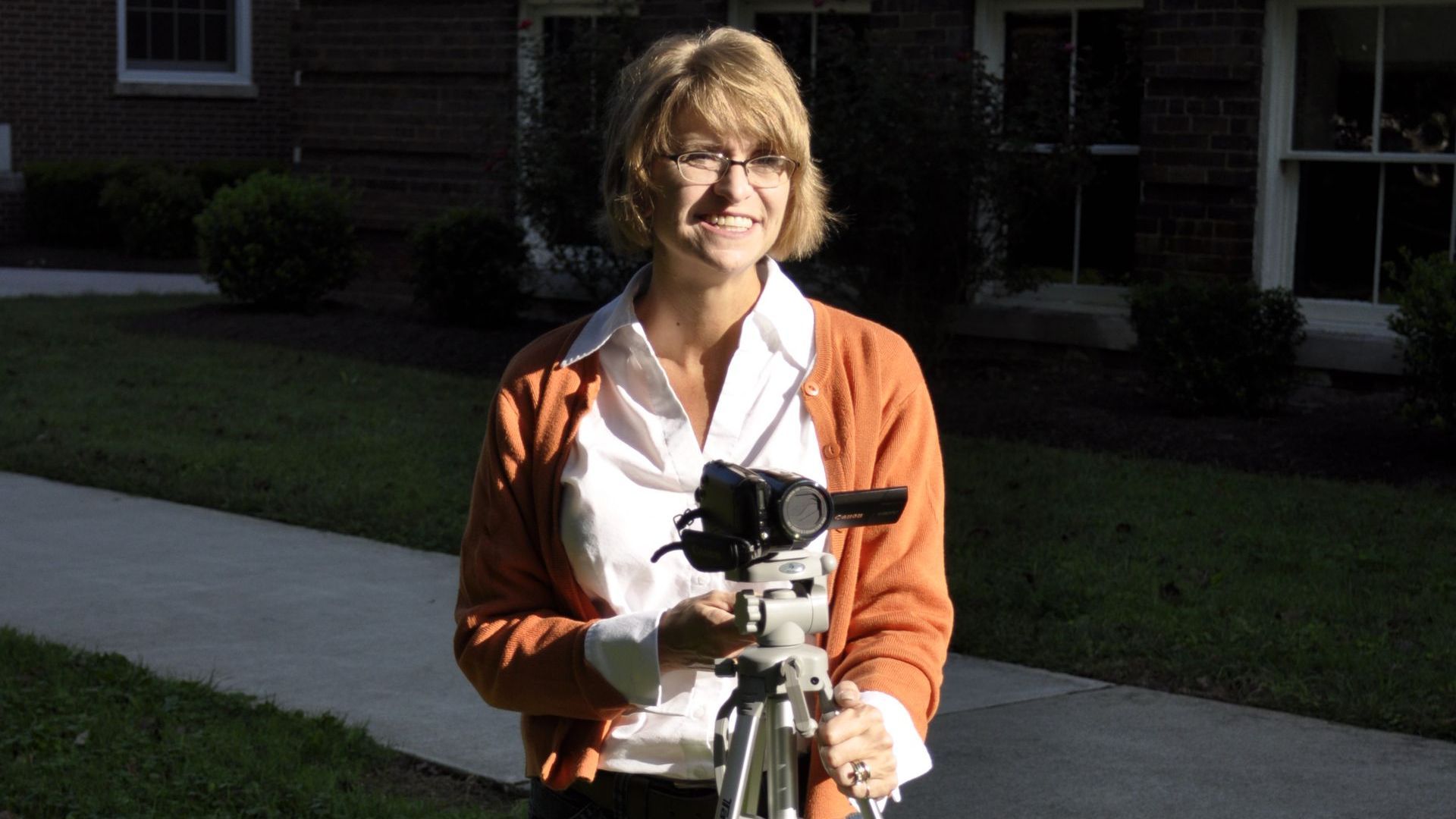 Dr. Christine Marley-Frederick holding a mounted camera.