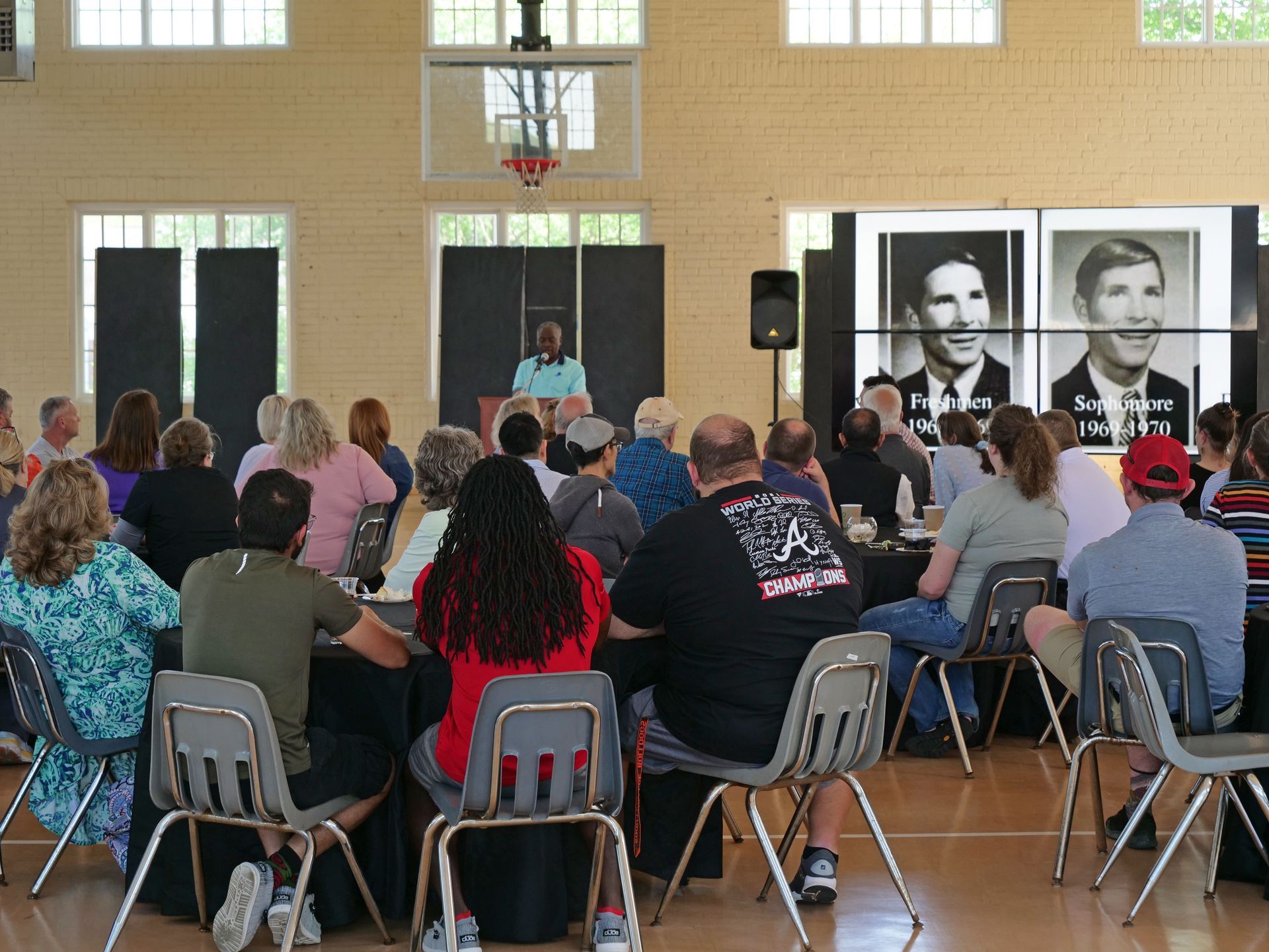 Dr. Fidelis Achenchang speaking at the podium as the crowd looks on.