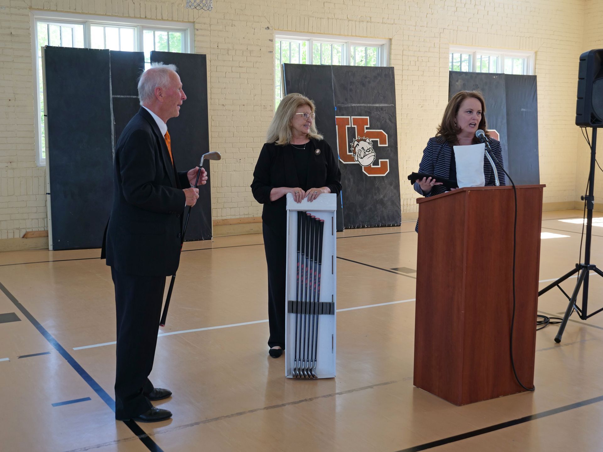 Dr. Marcia Hawkins and Dr. Marisa Greer gift Dr. Inkster a set of golf clubs.