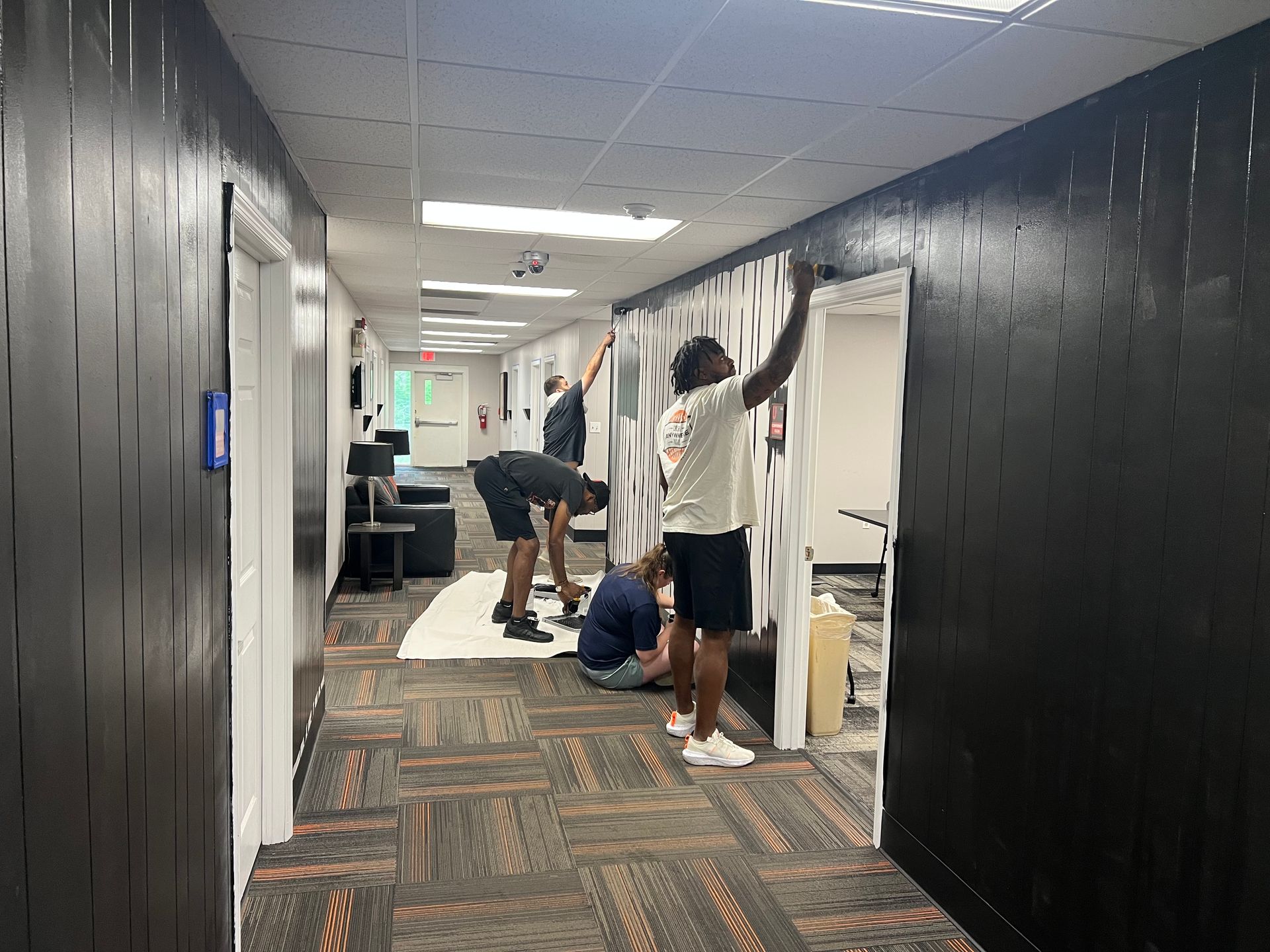 photo shows coaches painting in the athletic complex