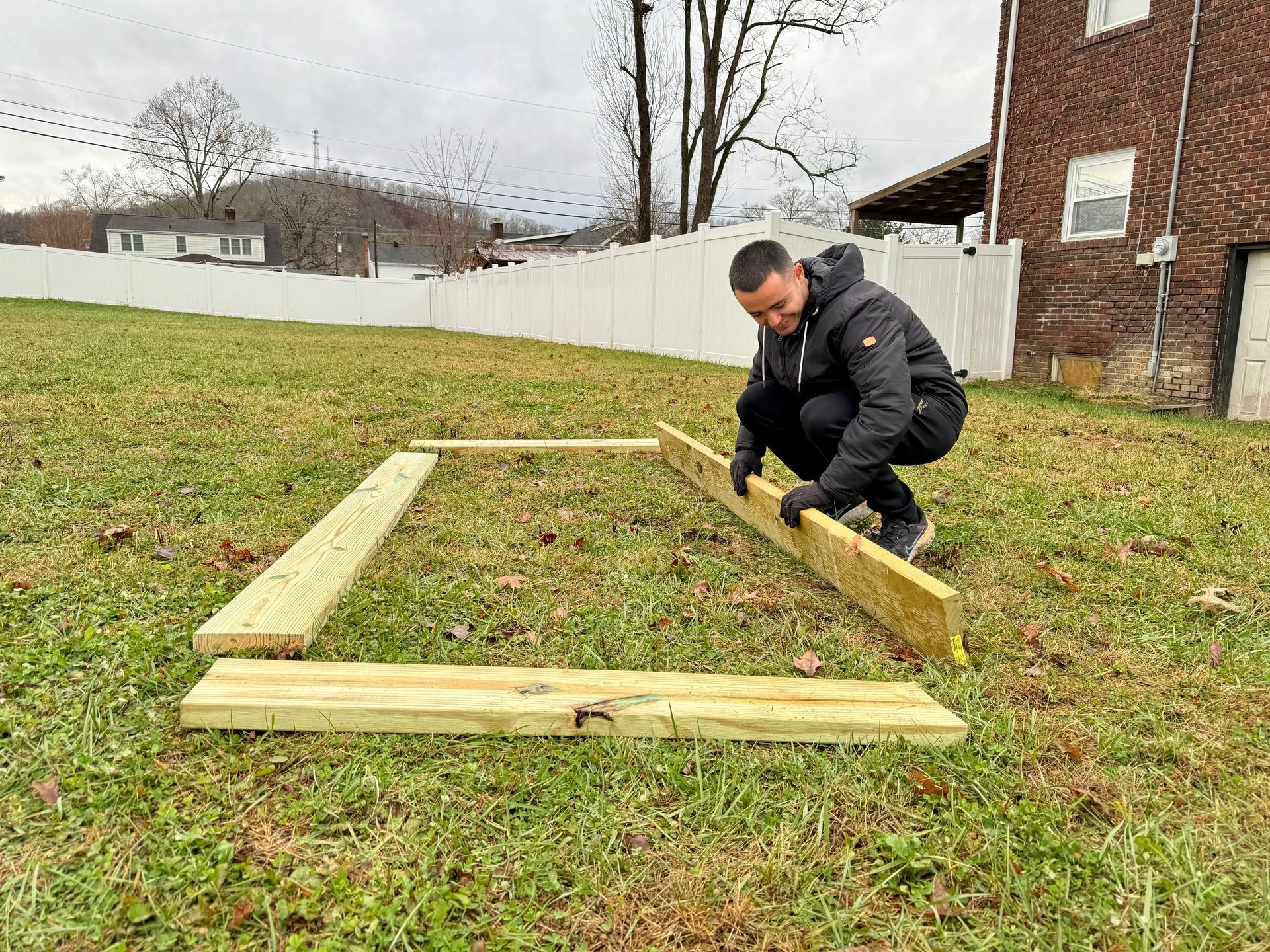 Wooden planks laid out on grass.