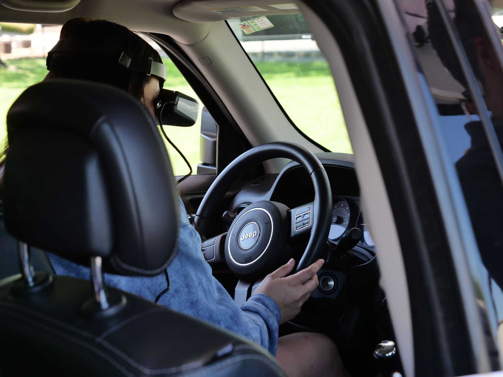 A student sitting behind the wheel in the simulated driving experience of the Arrive Alive Tour.