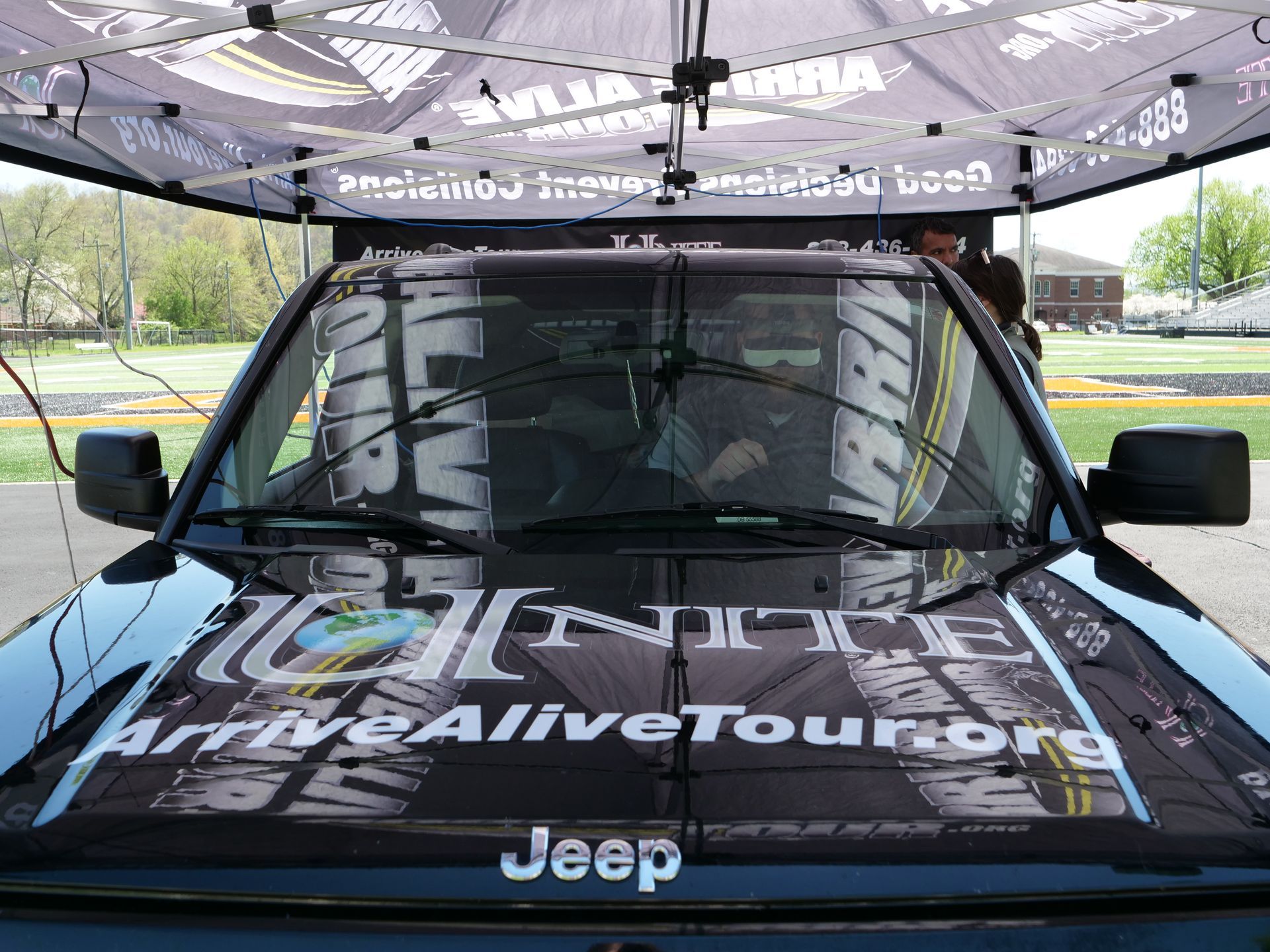 A black SUV used for the simulated driving experience. On hood of the car are logos for Knox County Operation Unite and the Arrive Alive Tour.