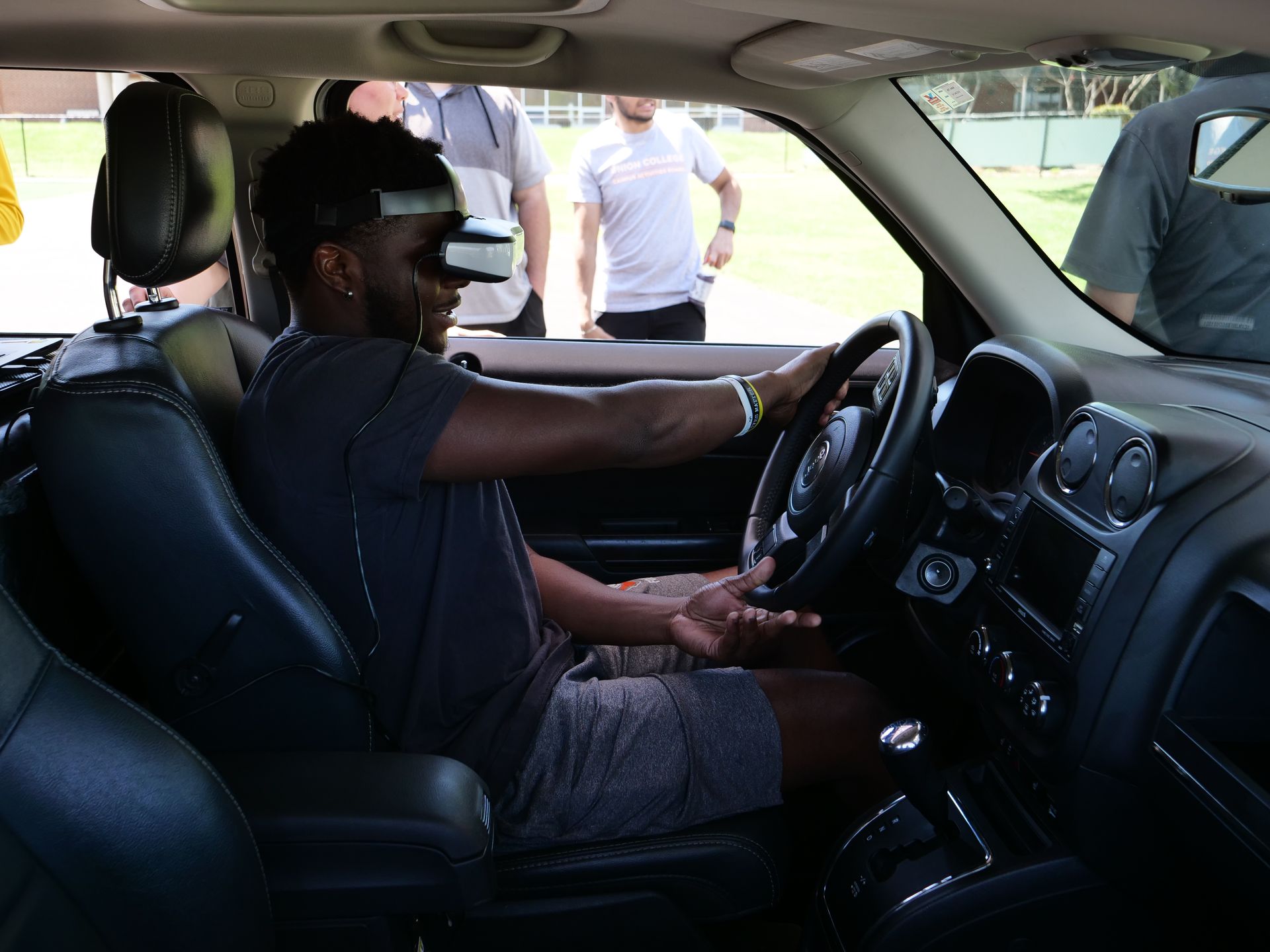 A student sitting behind the wheel in the simulated driving experience of the Arrive Alive Tour.