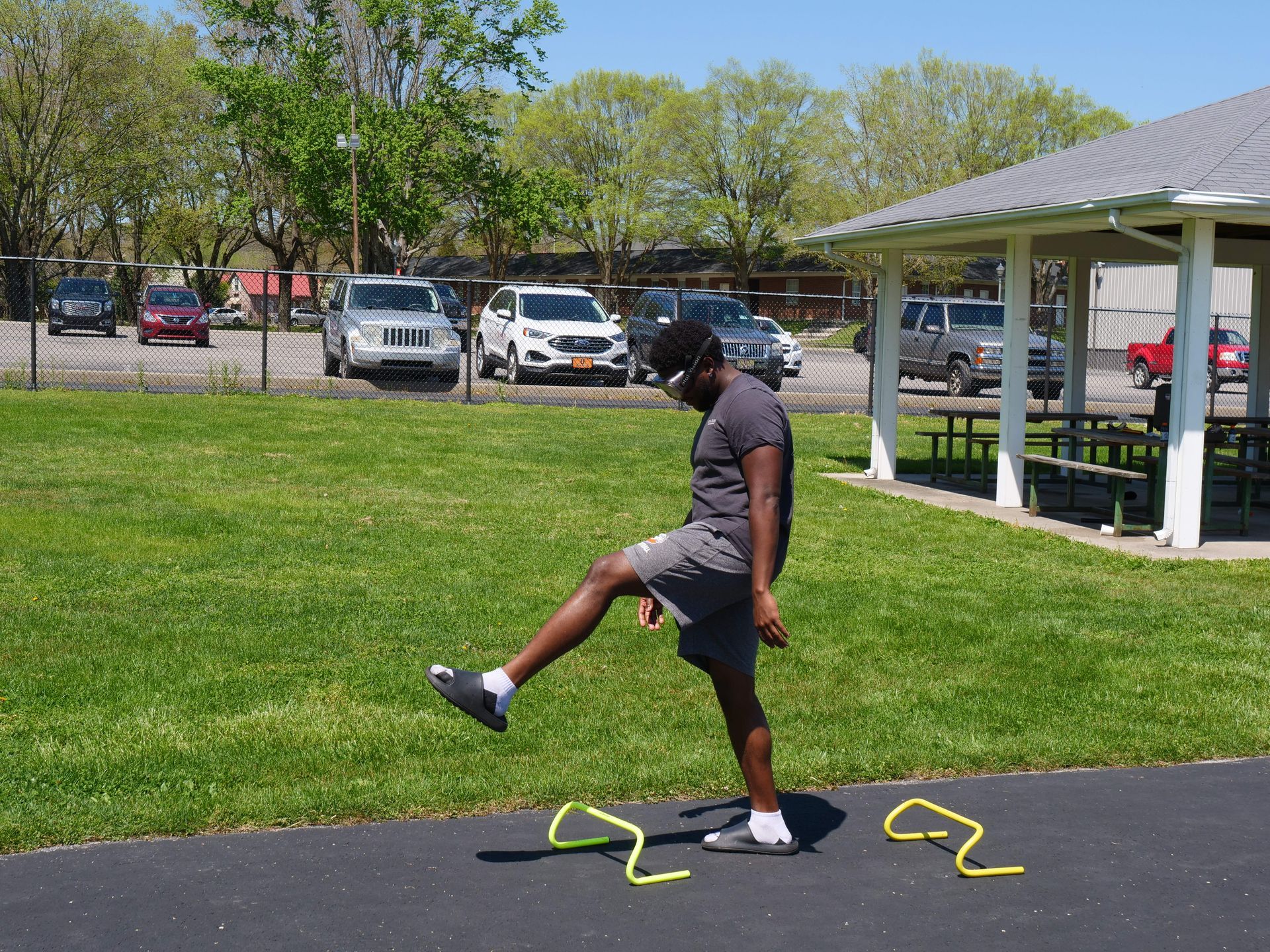 A student trying to walk through a small obstacle course while wearing drunk goggles.