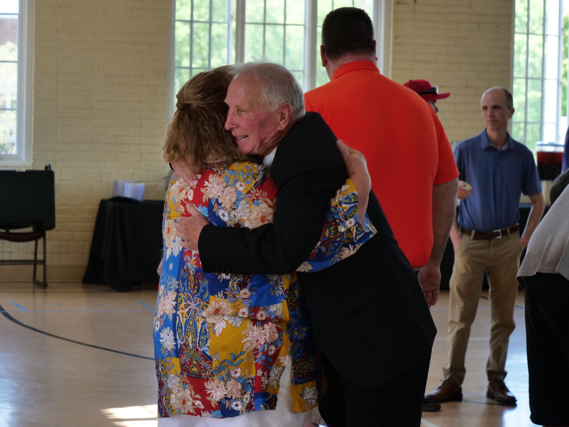 Dr. Inkster hugging a retirement party attendee.