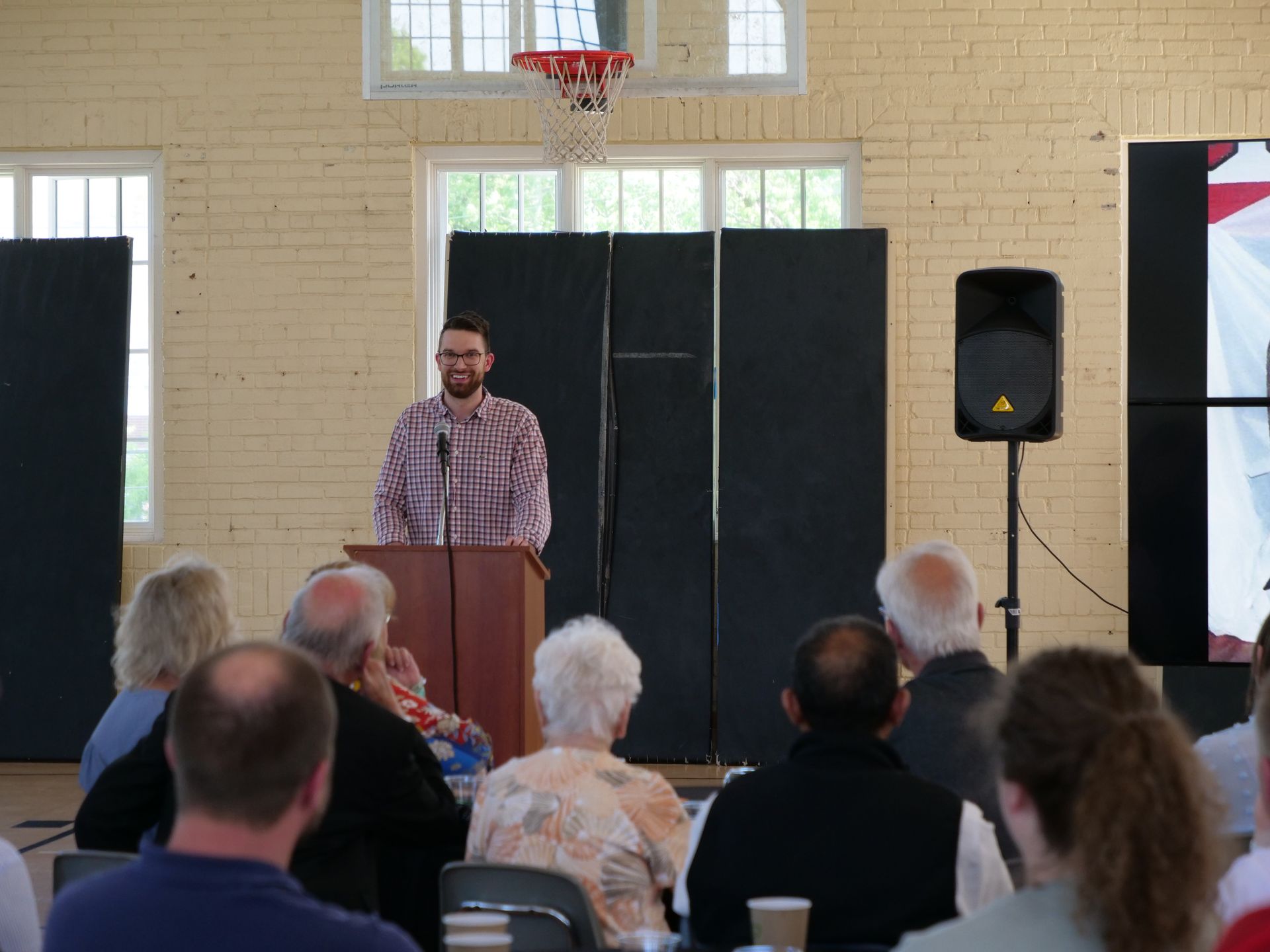 Chris Gibson speaking at the podium.