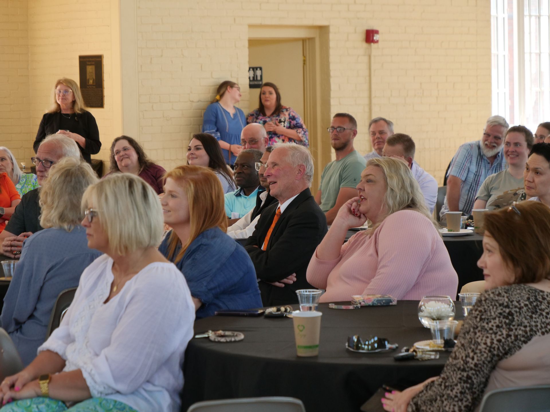 Dr. Inkster sitting in the crowd smiling.