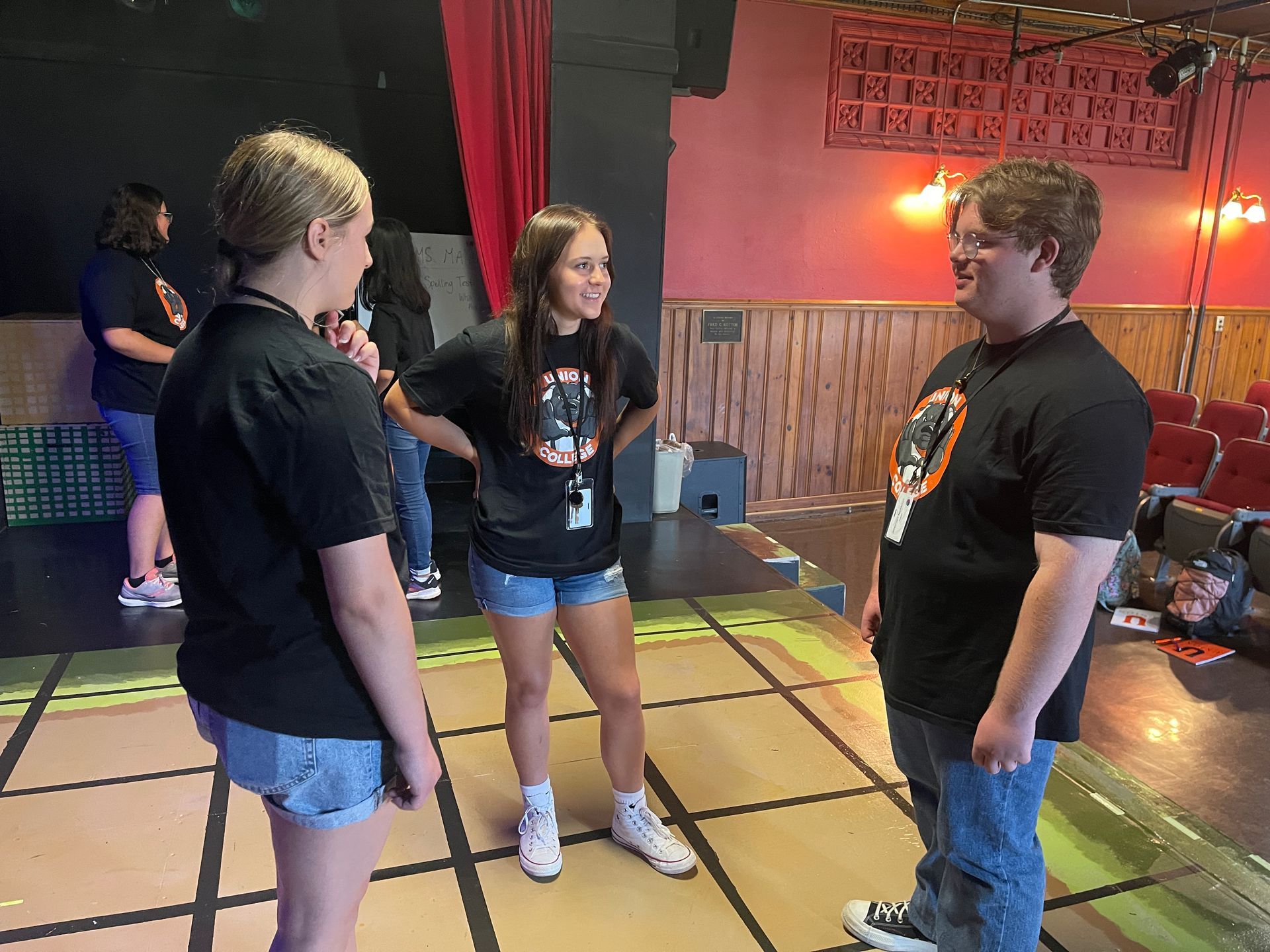 A group of students chatting in Union's theater.