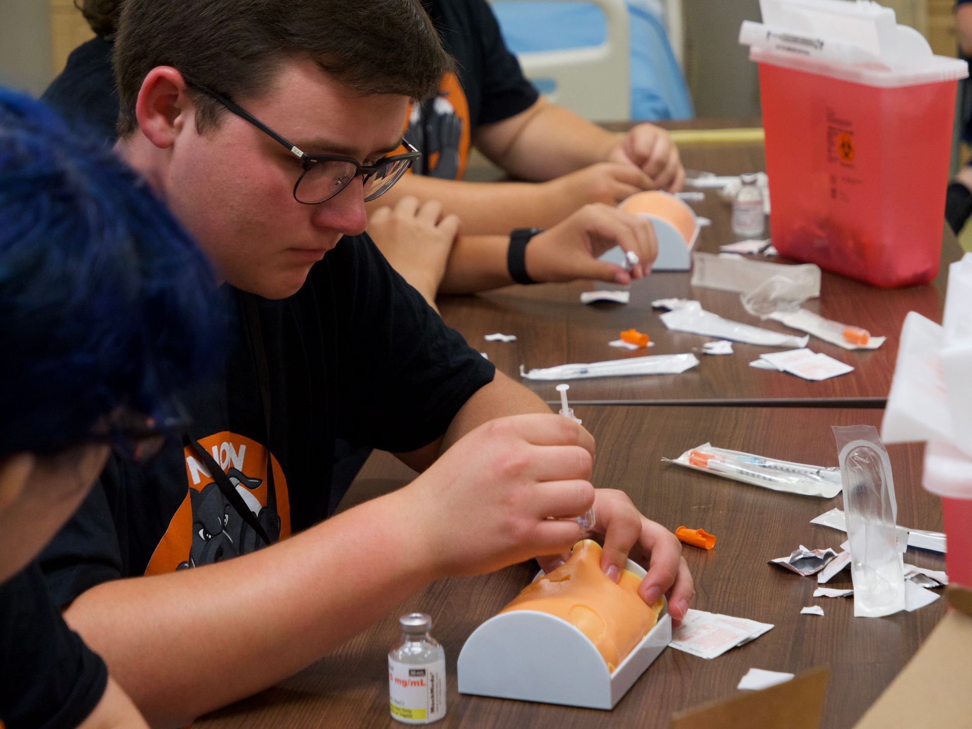 A student injecting a slab of gel as part of a lab activity.