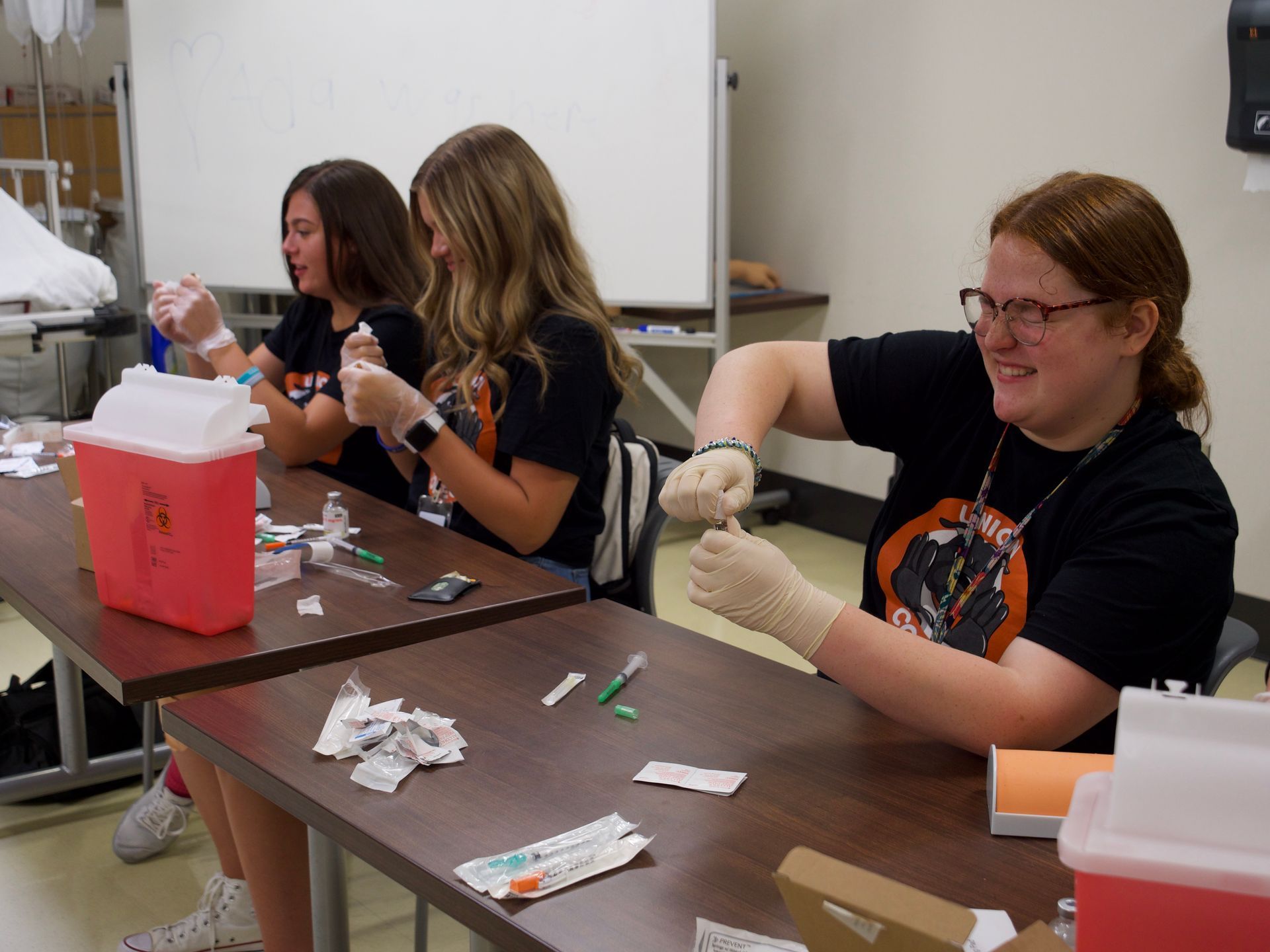 Students break ampules in one of their nursing activities.