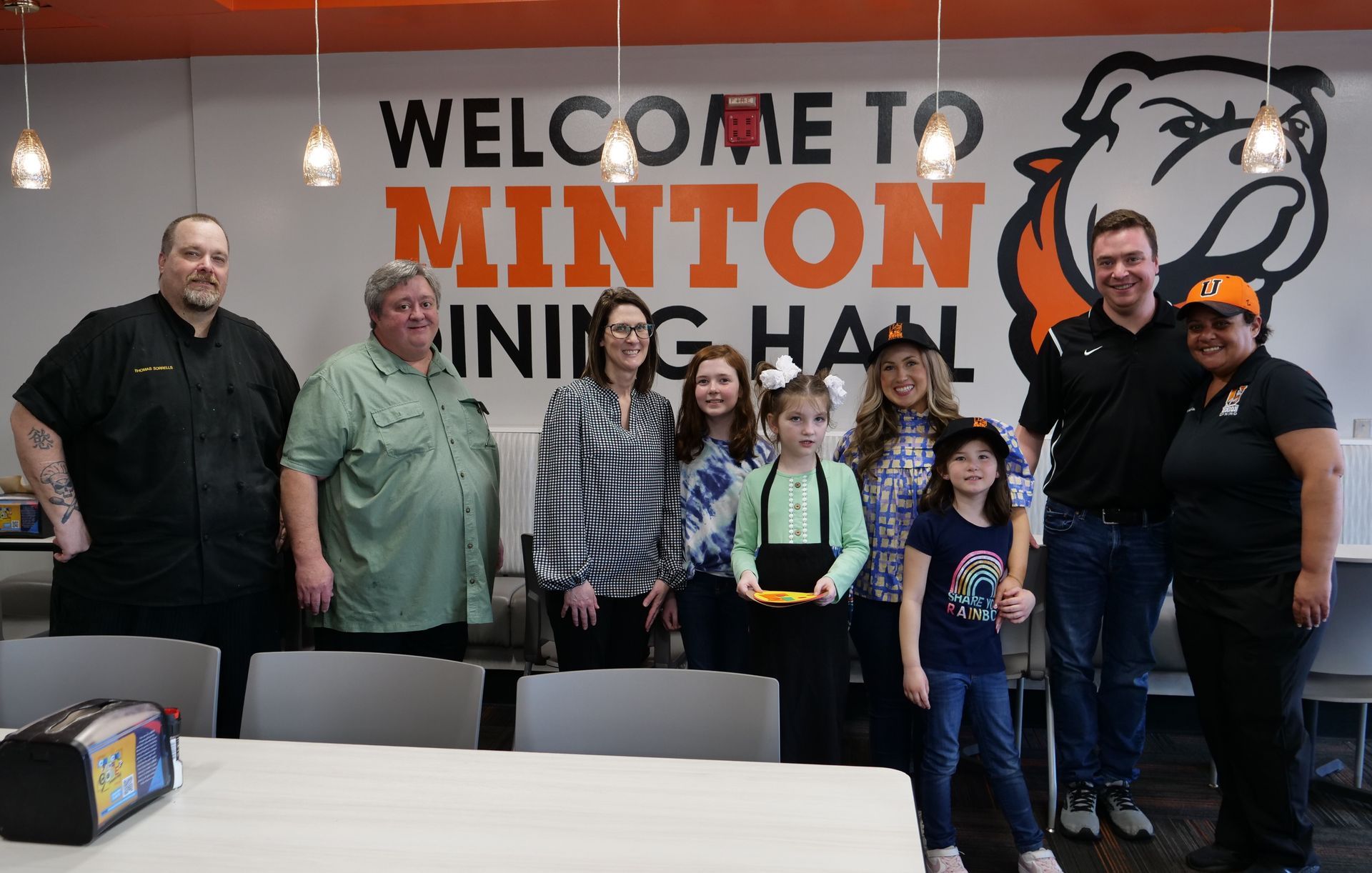 Libby Kate Vaughn, James Becknell, Union Dining staff, and all attendees gathered together by the Minton Dining Hall sign.