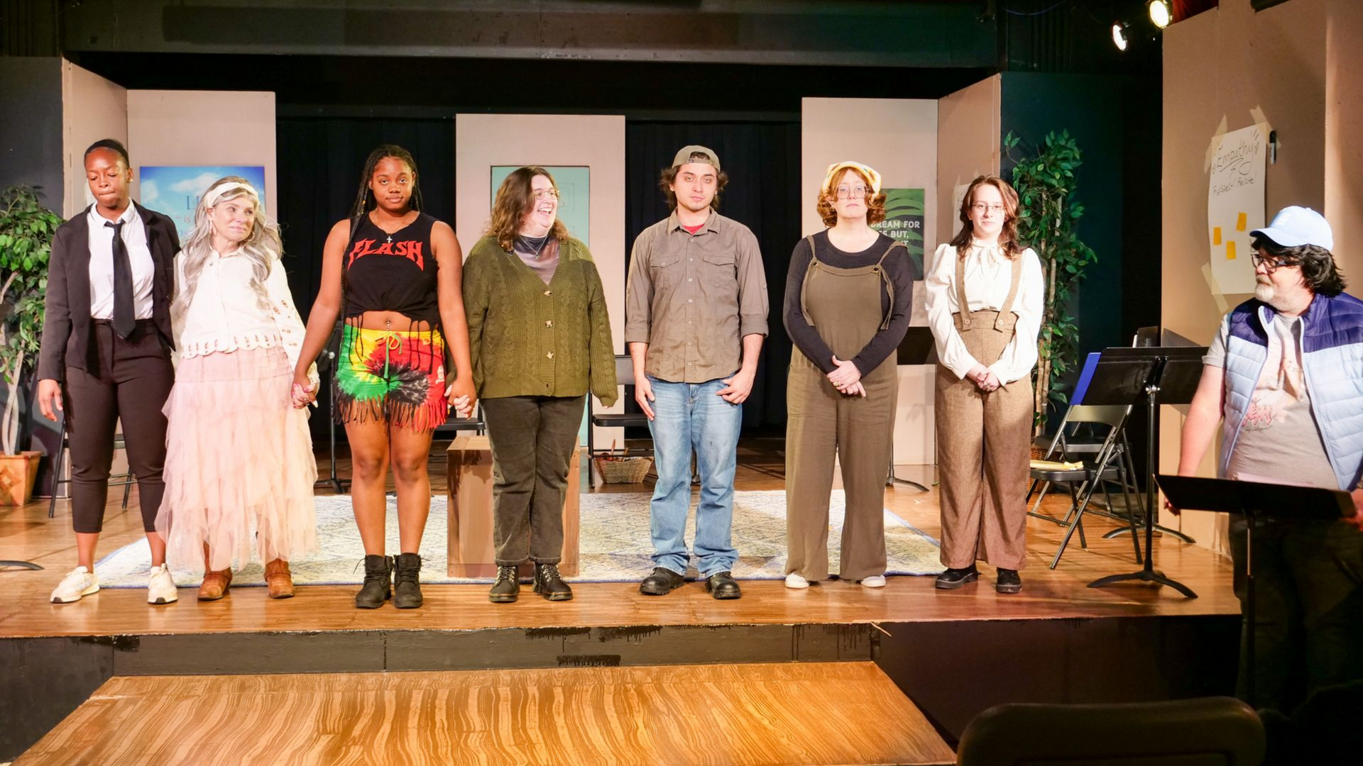 The cast of Group Therapy: The Musical standing in a line on stage during rehearsal.