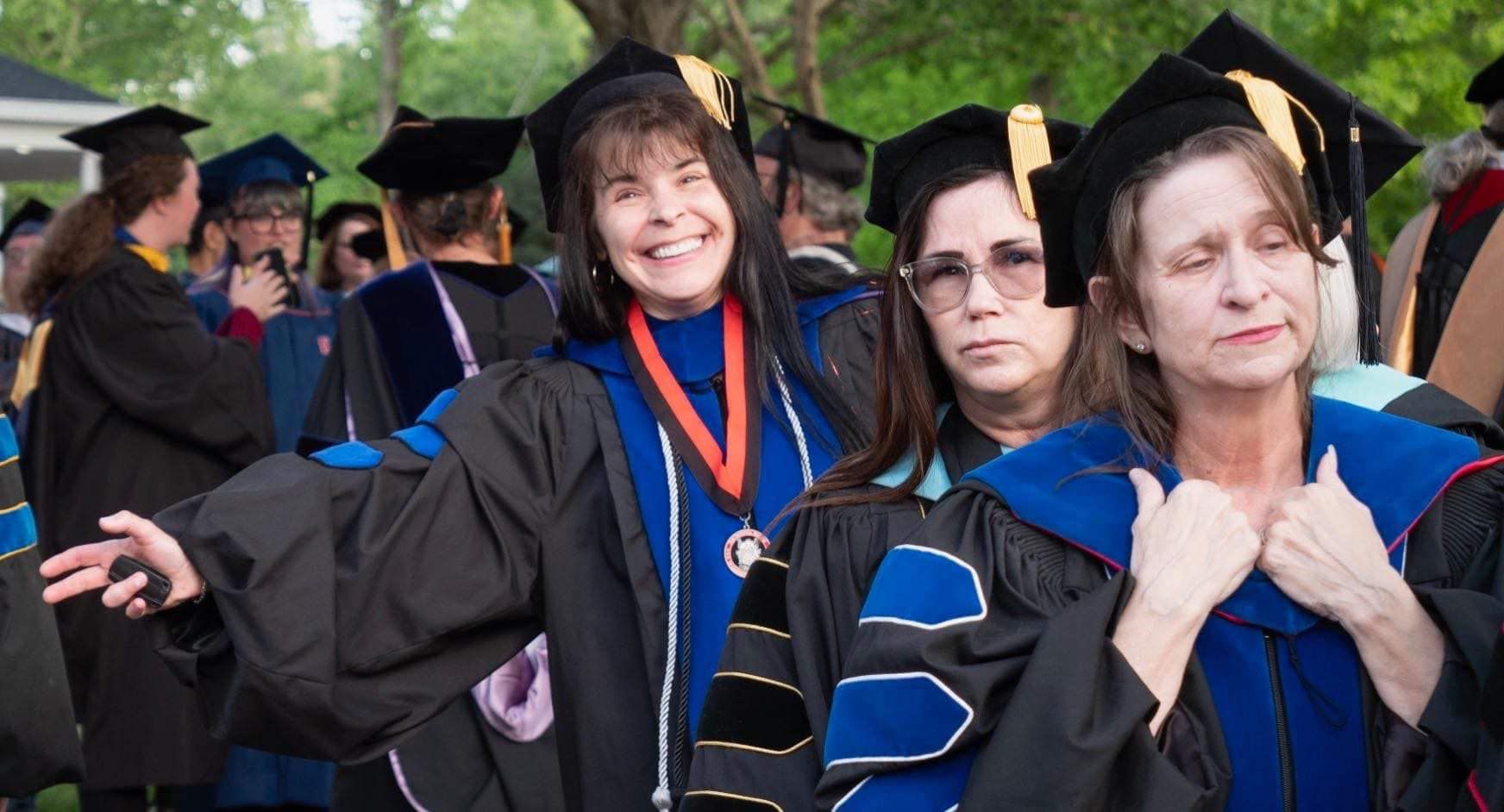 Dr. Christine Marley-Frederick leading a line of AVÍ·µÈ²Õ professors at commencement with Dr. Lori Henderson and Dr. Stella Rostkowski following behind.