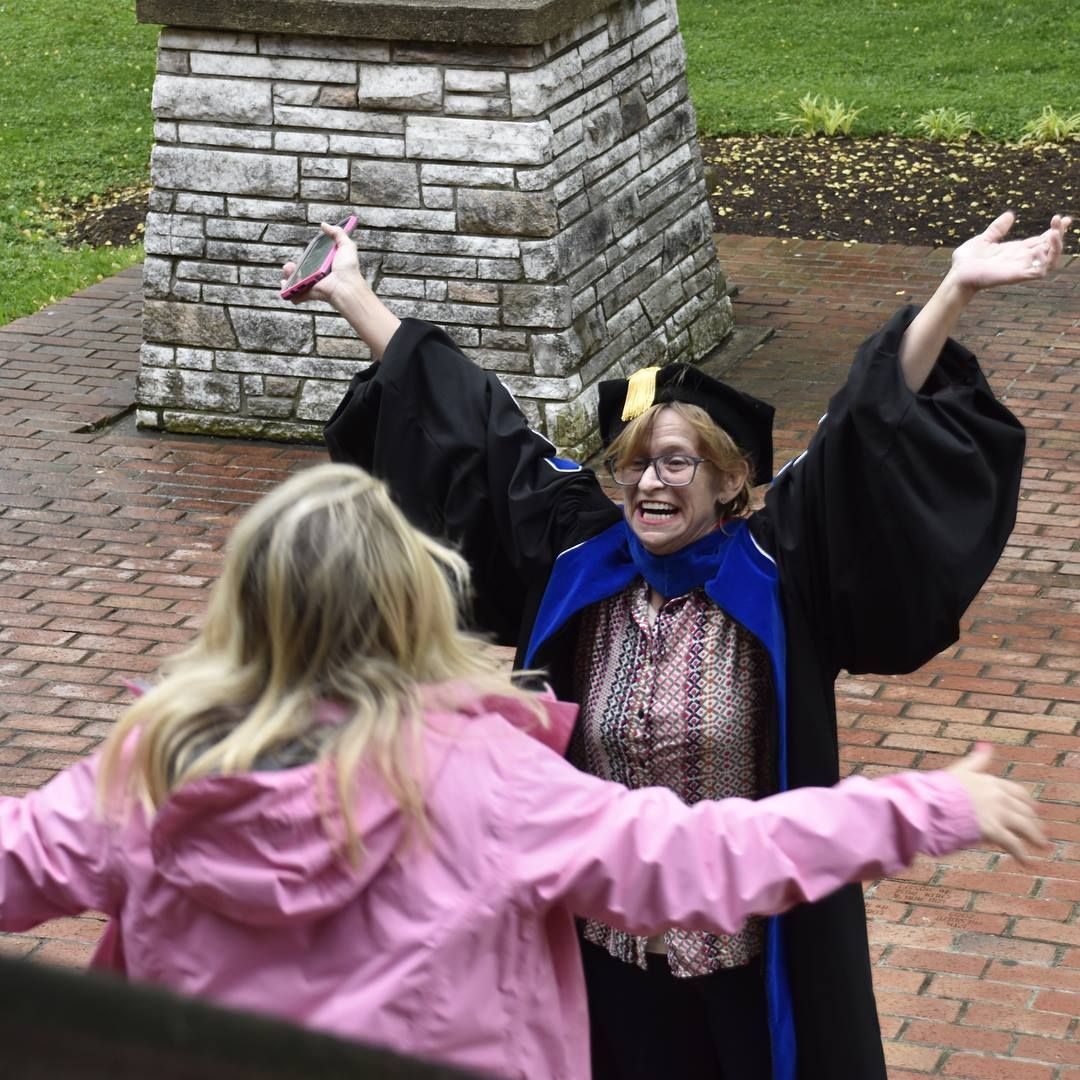 Dr. Christine Marley-Frederick excitedly greeting a friend at commencement.