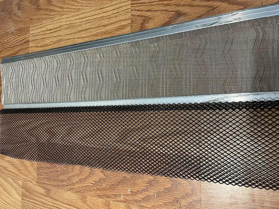A piece of metal is laying on a wooden surface