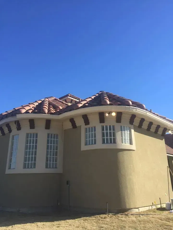 A house with a tiled roof and a lot of windows