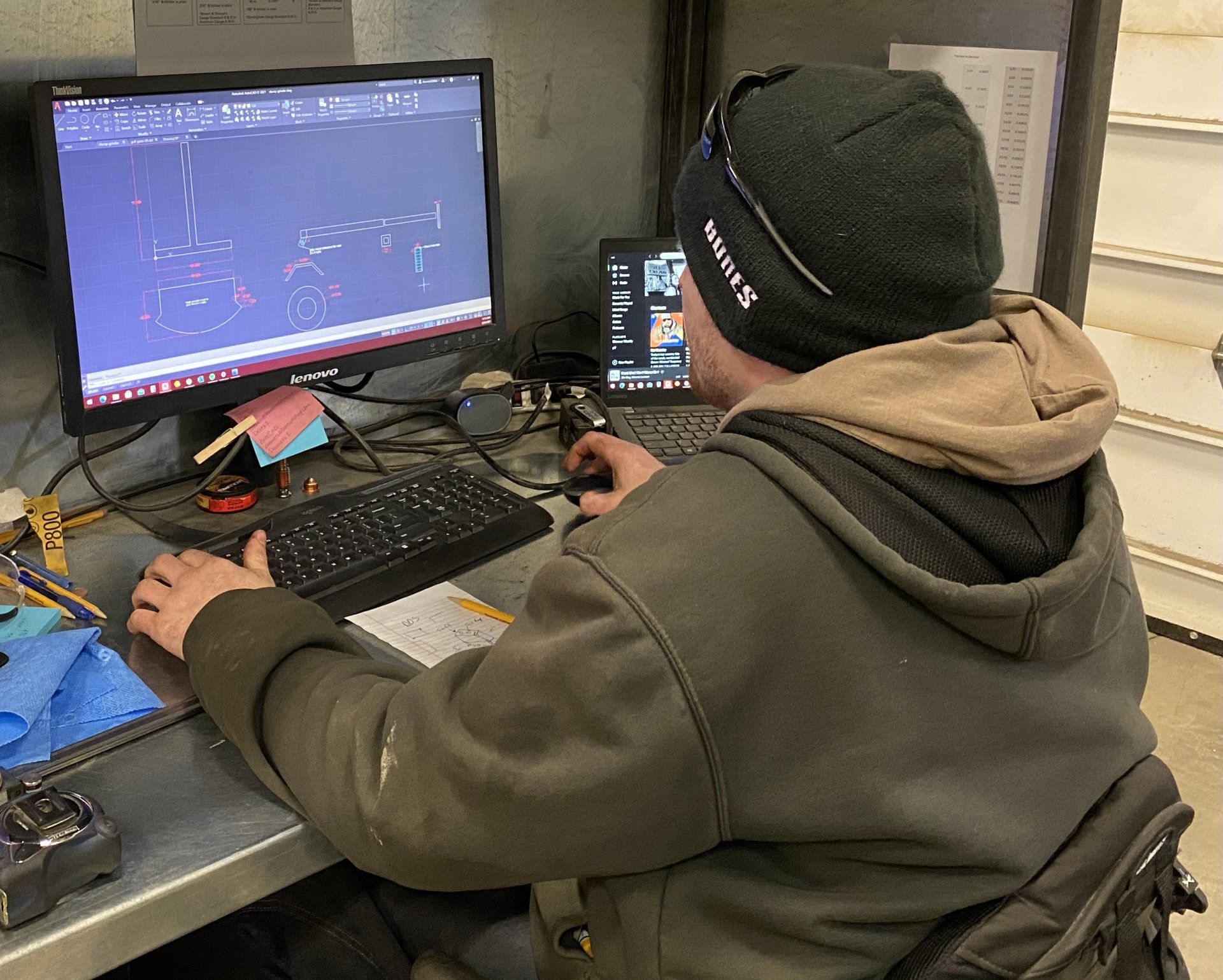A man is sitting at a desk using a computer.