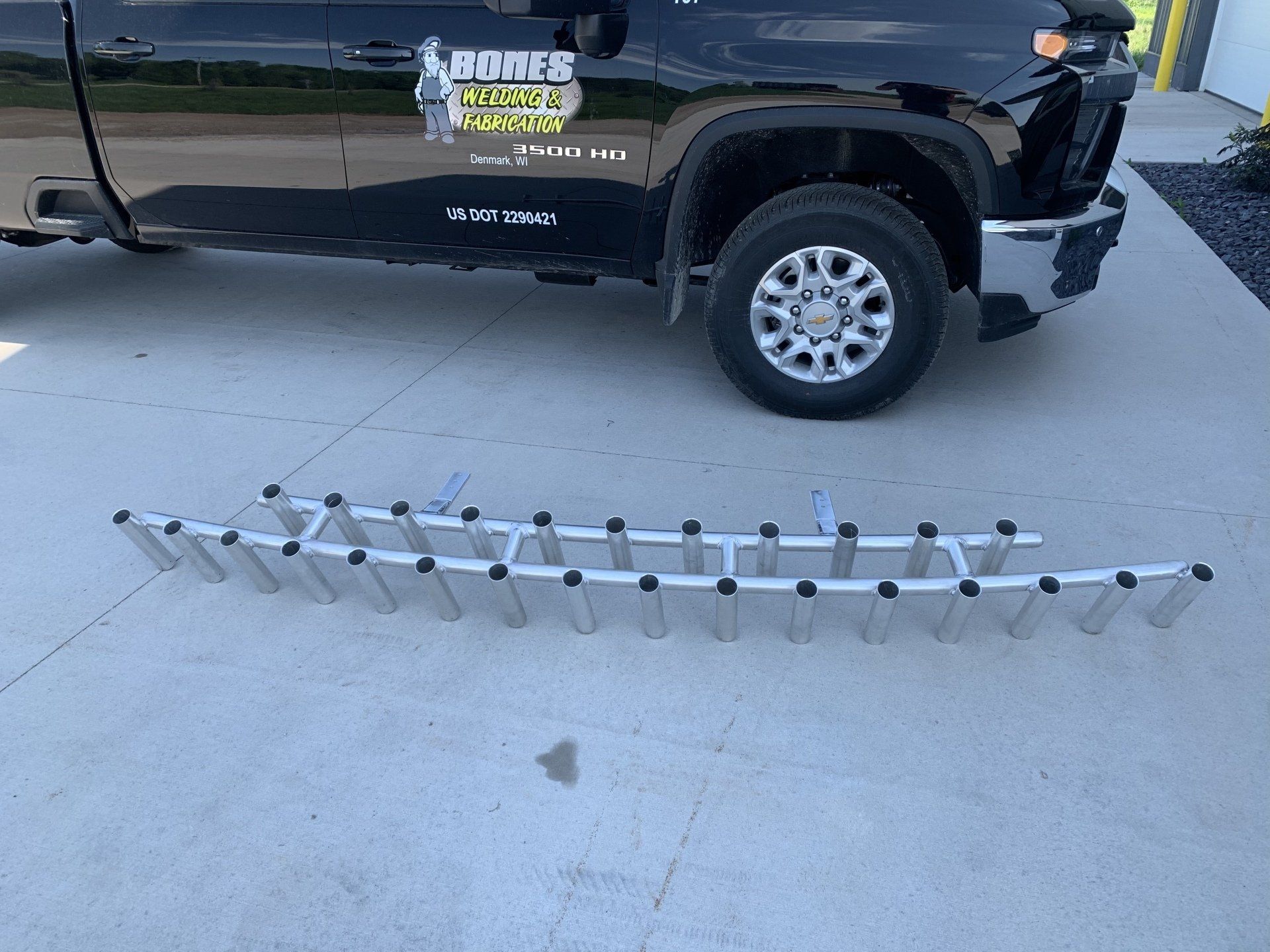 A black truck with a ladder attached to the back of it