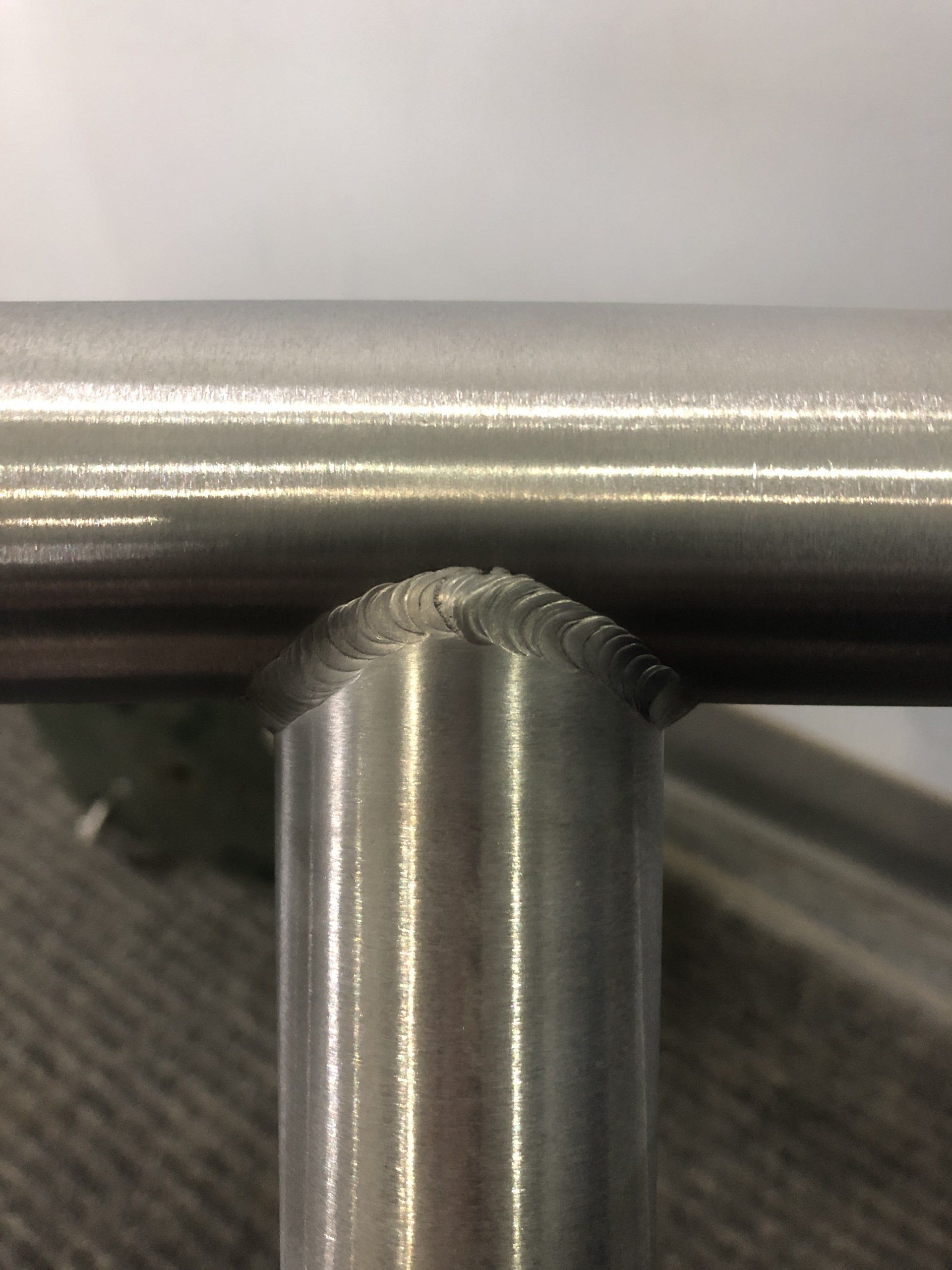 A close up of a stainless steel pipe on a table.