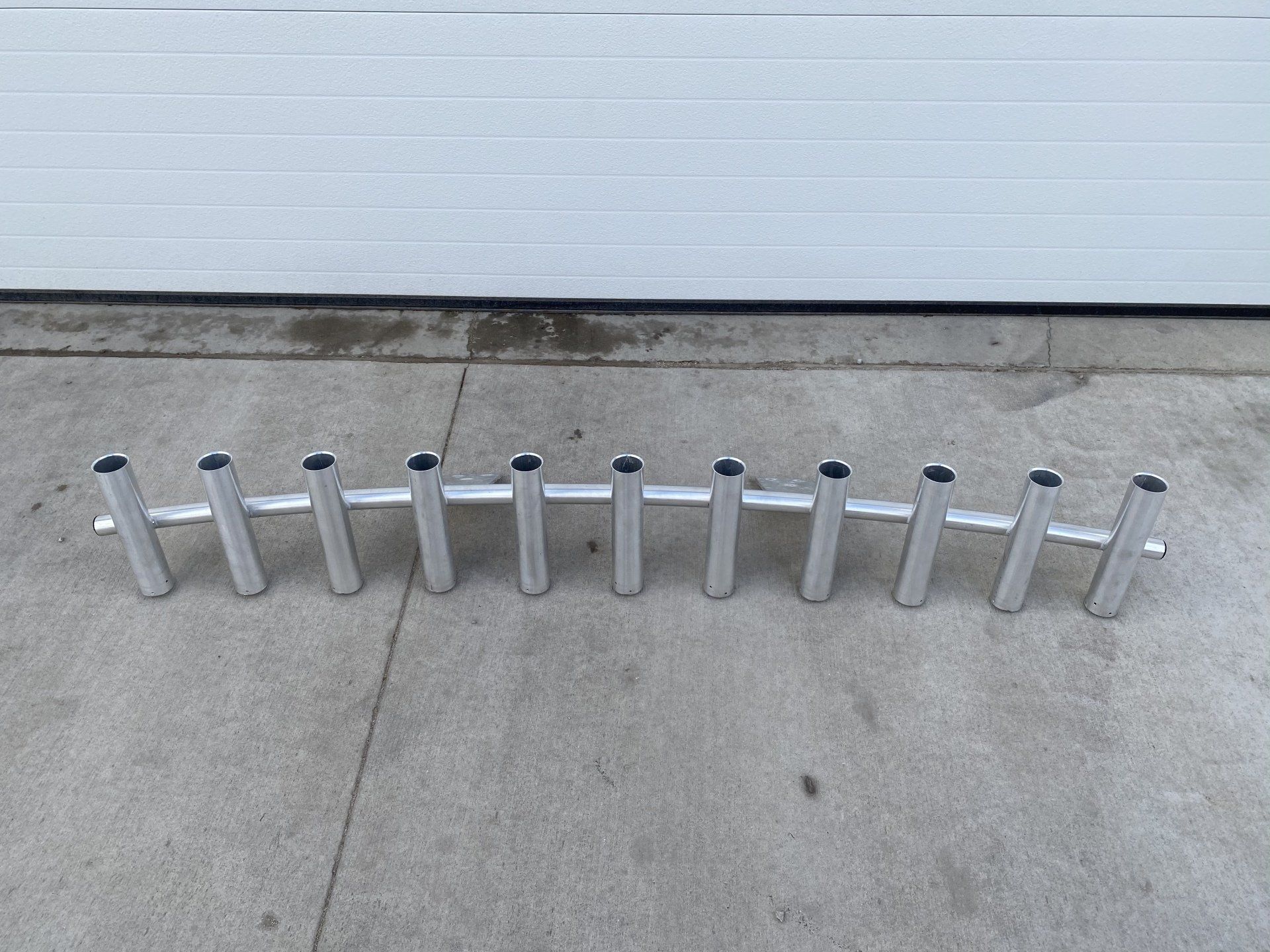 A row of metal pipes are lined up in a row