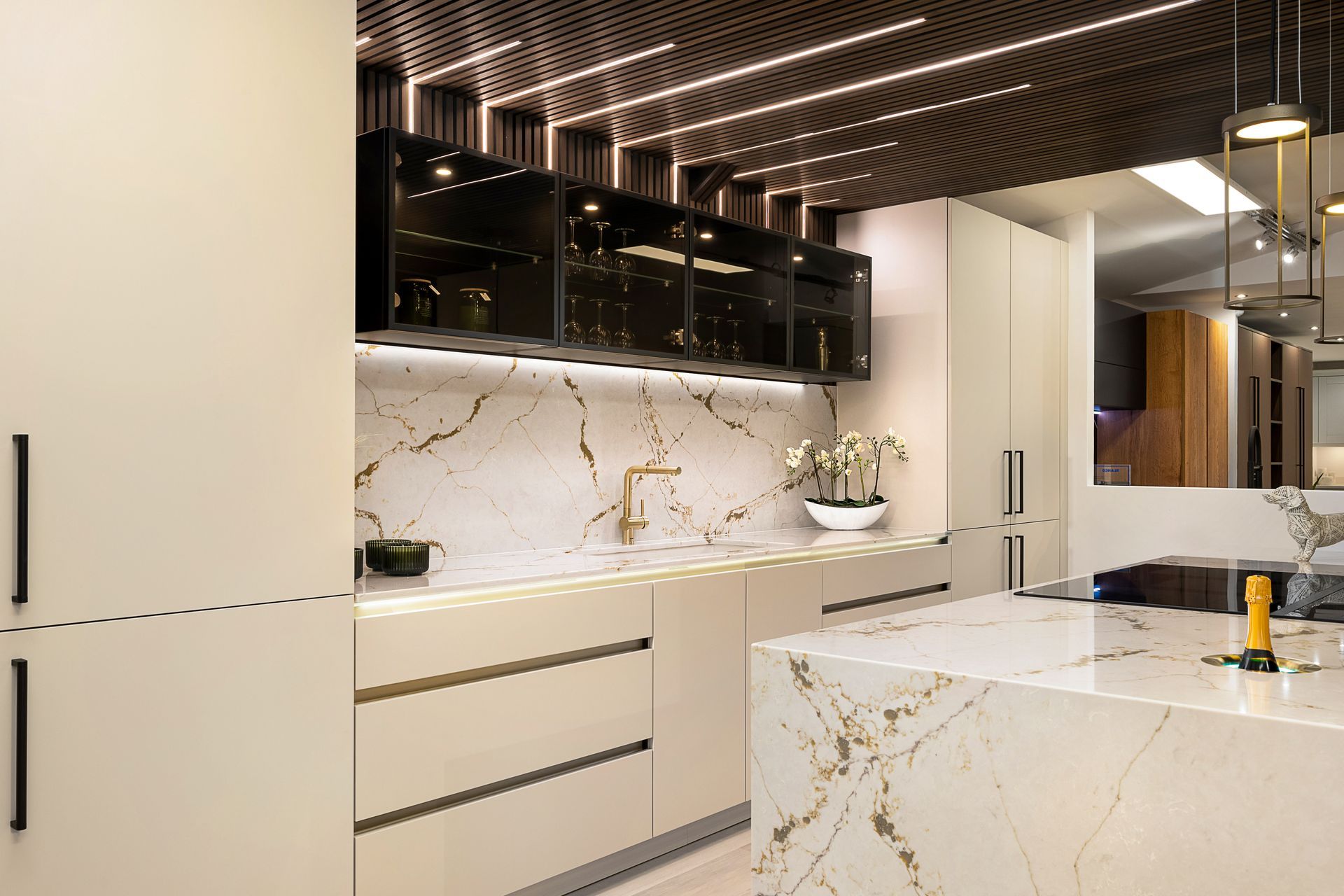 A luxury kitchen with a large island and marble worktops