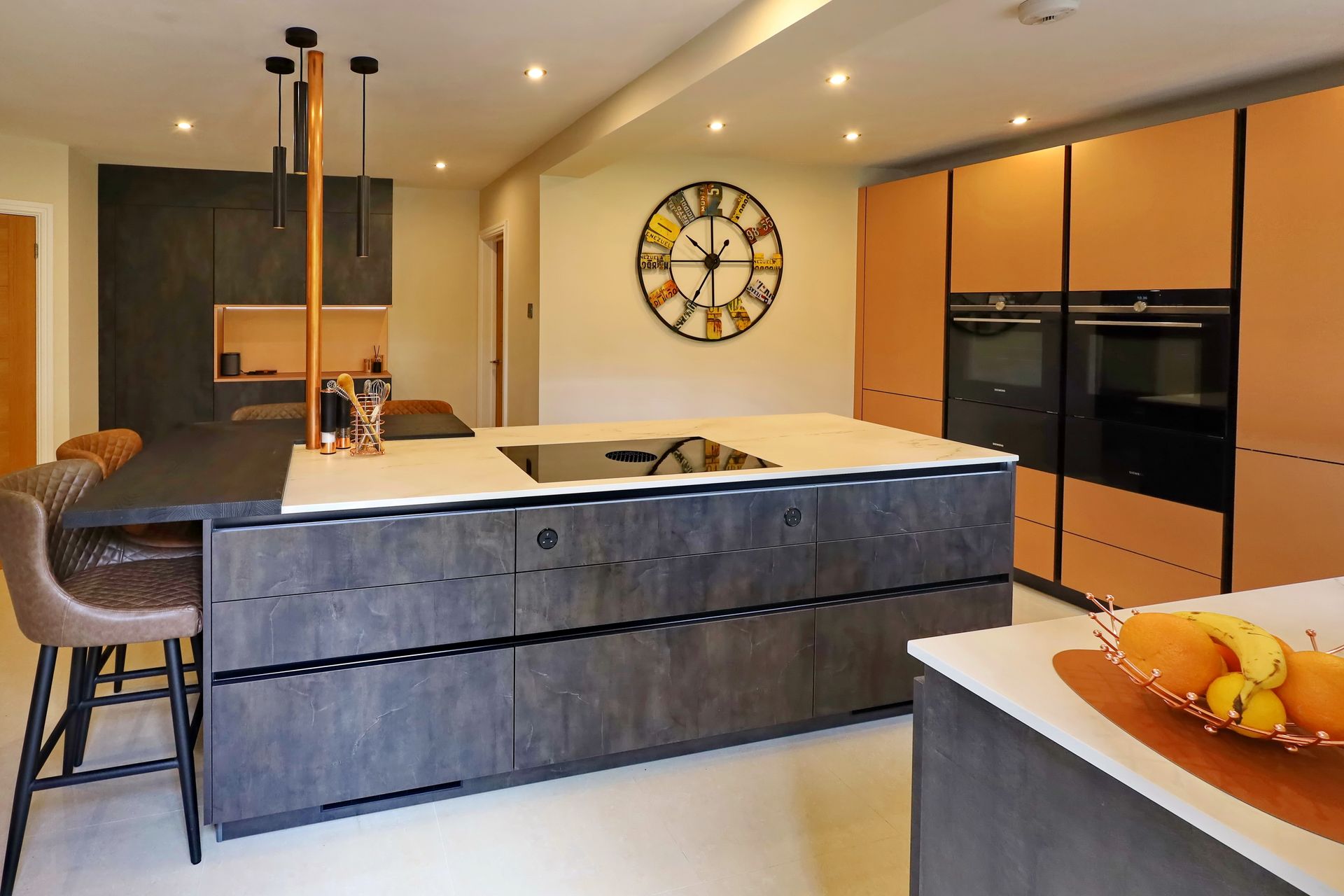 Harvey contemporary kitchen with grey, handleless units and teal furnishings. Designed by exact Kitchens in Wokingham.
