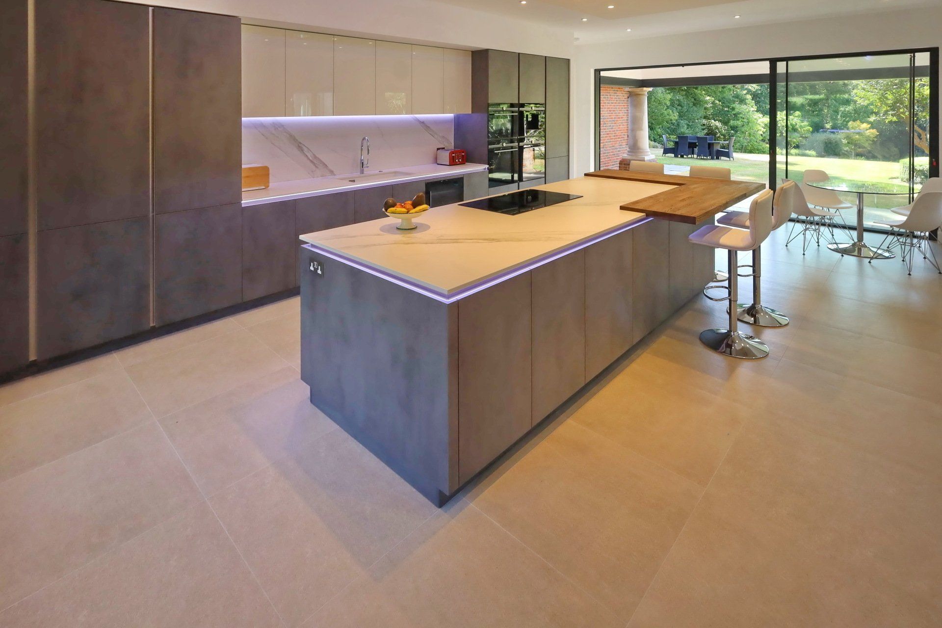 Contemporary handleless kitchen with large island and LED lighting by exact
