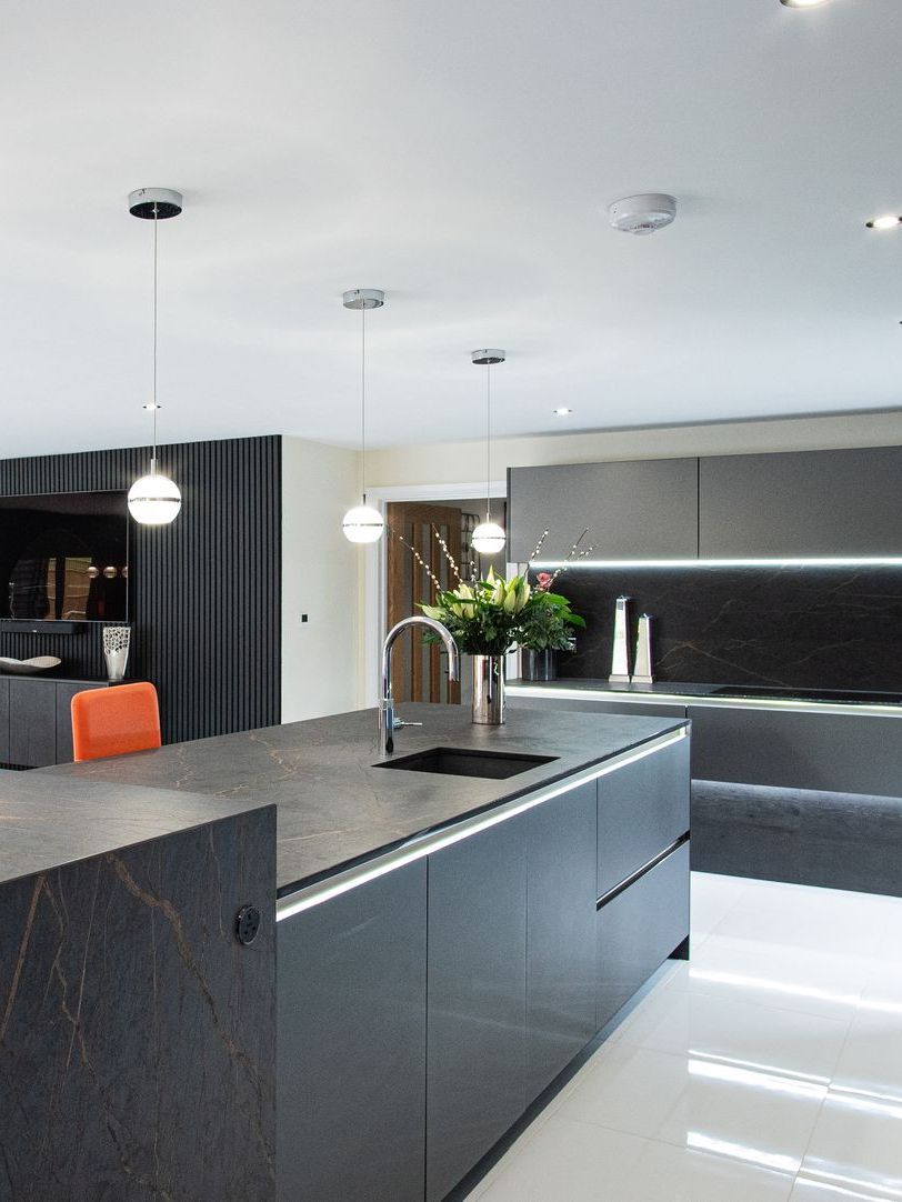 Harvey contemporary kitchen with grey, handleless units and teal furnishings. Designed by exact Kitchens in Wokingham.