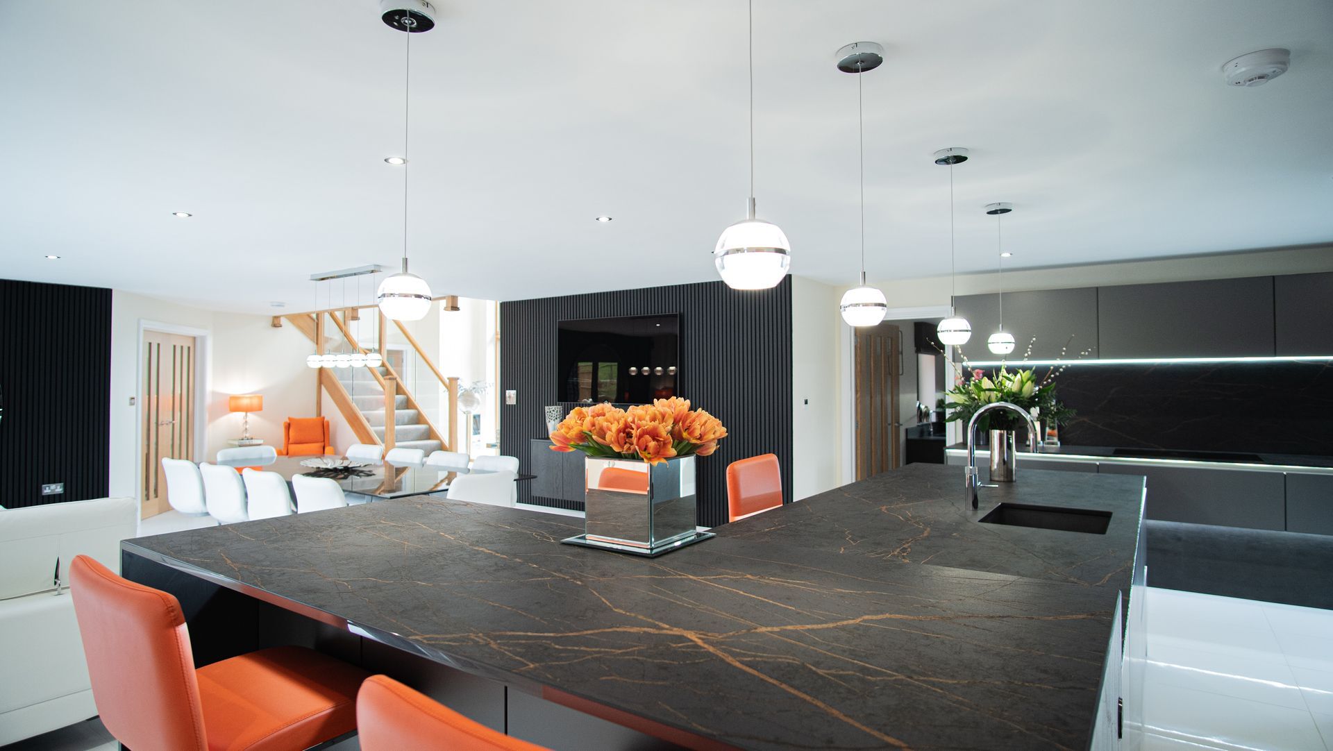 Harvey contemporary kitchen with grey, handleless units and teal furnishings. Designed by exact Kitchens in Wokingham.