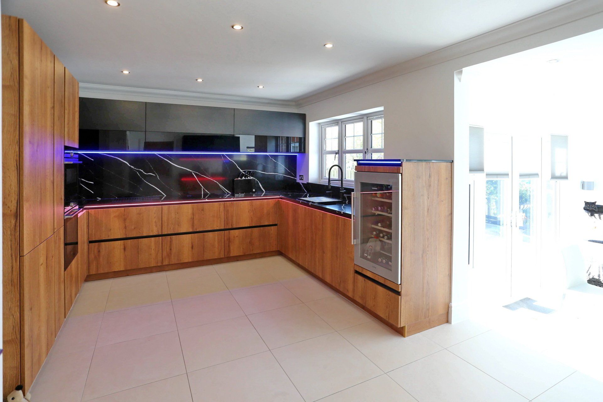 Harvey contemporary kitchen with grey, handleless units and teal furnishings. Designed by exact Kitchens in Wokingham.