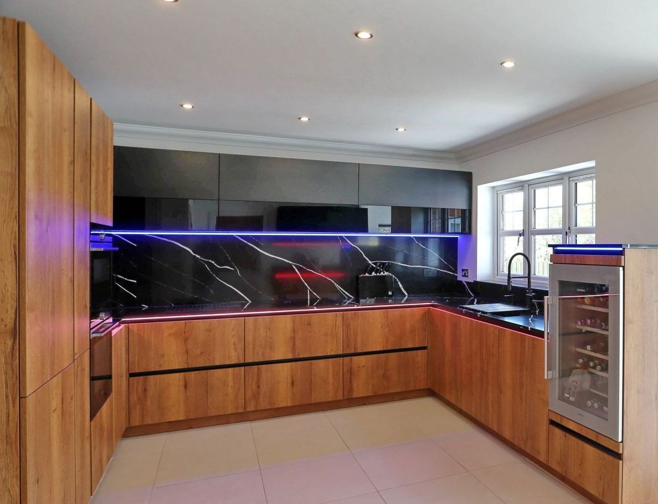 Harvey contemporary kitchen with grey, handleless units and teal furnishings. Designed by exact Kitchens in Wokingham.