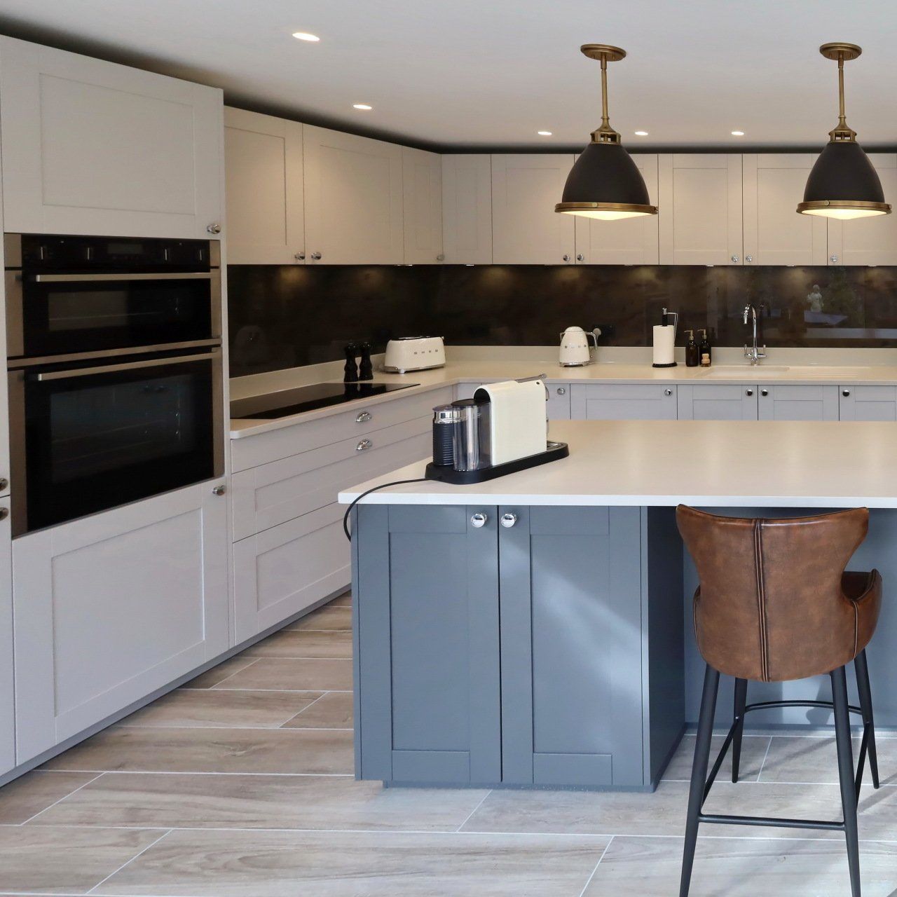 Harvey contemporary kitchen with grey, handleless units and teal furnishings. Designed by exact Kitchens in Wokingham.
