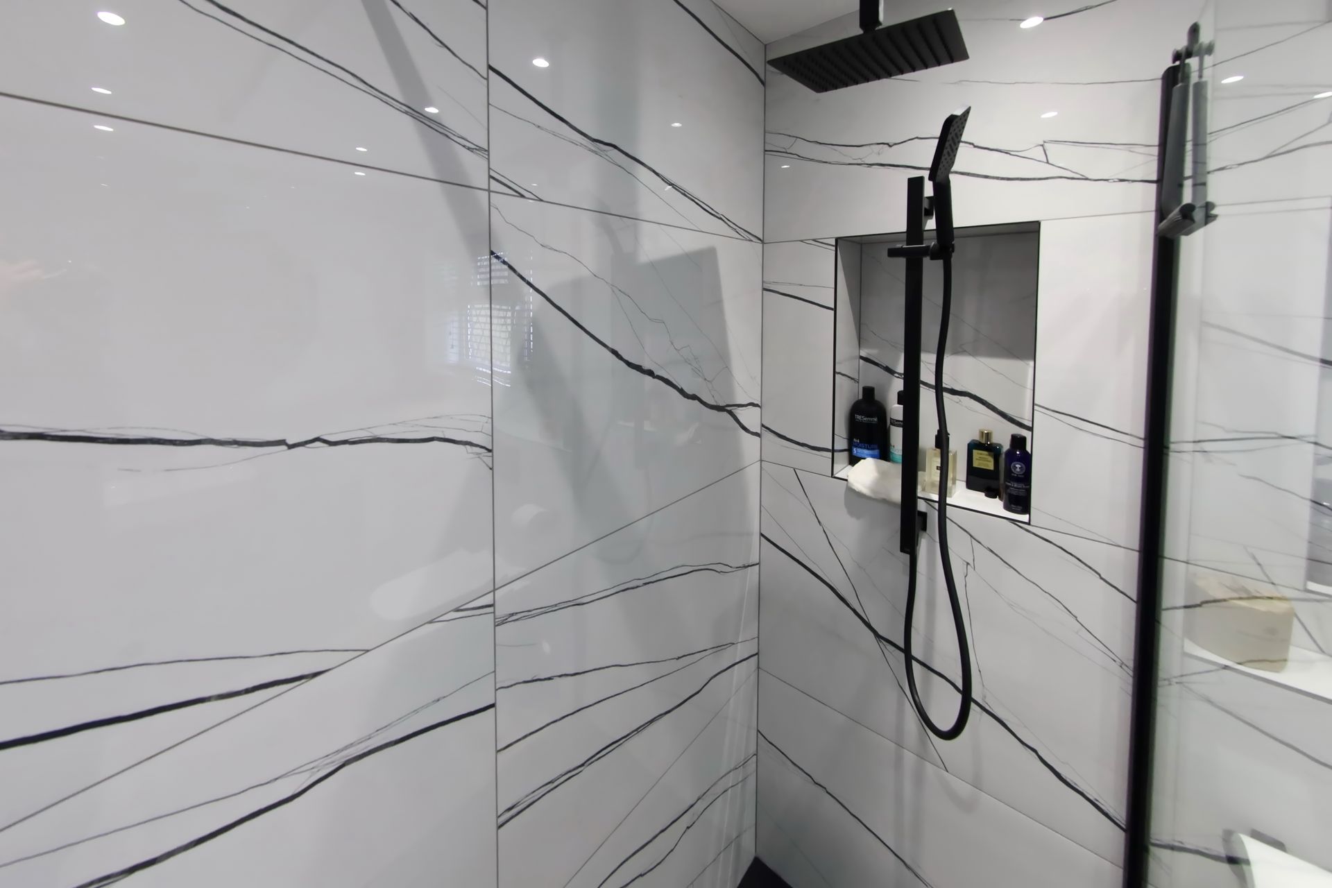 Close up of large white bathroom tiles with striking black marbling