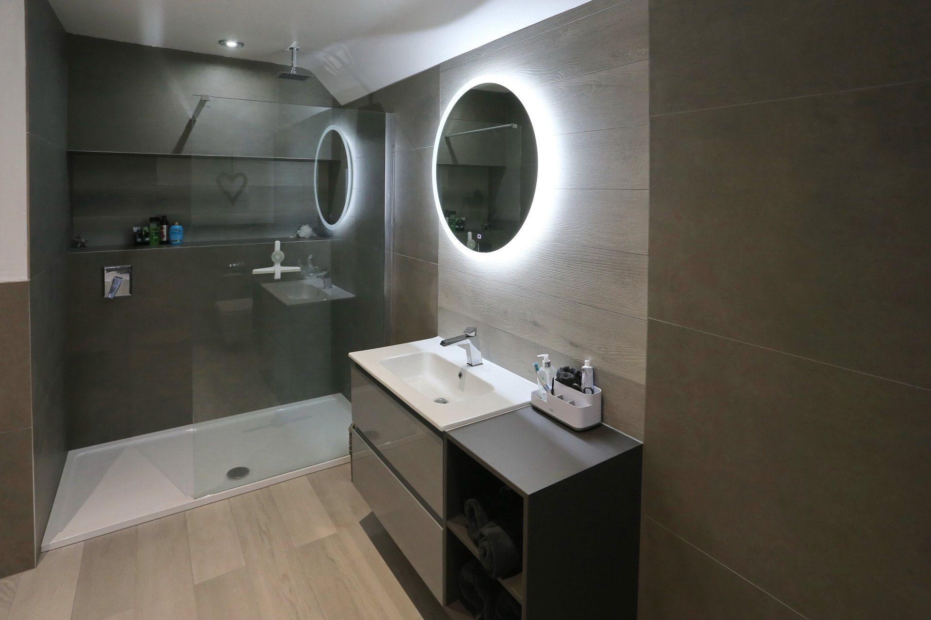 Family bathroom with light-up mirror by exact