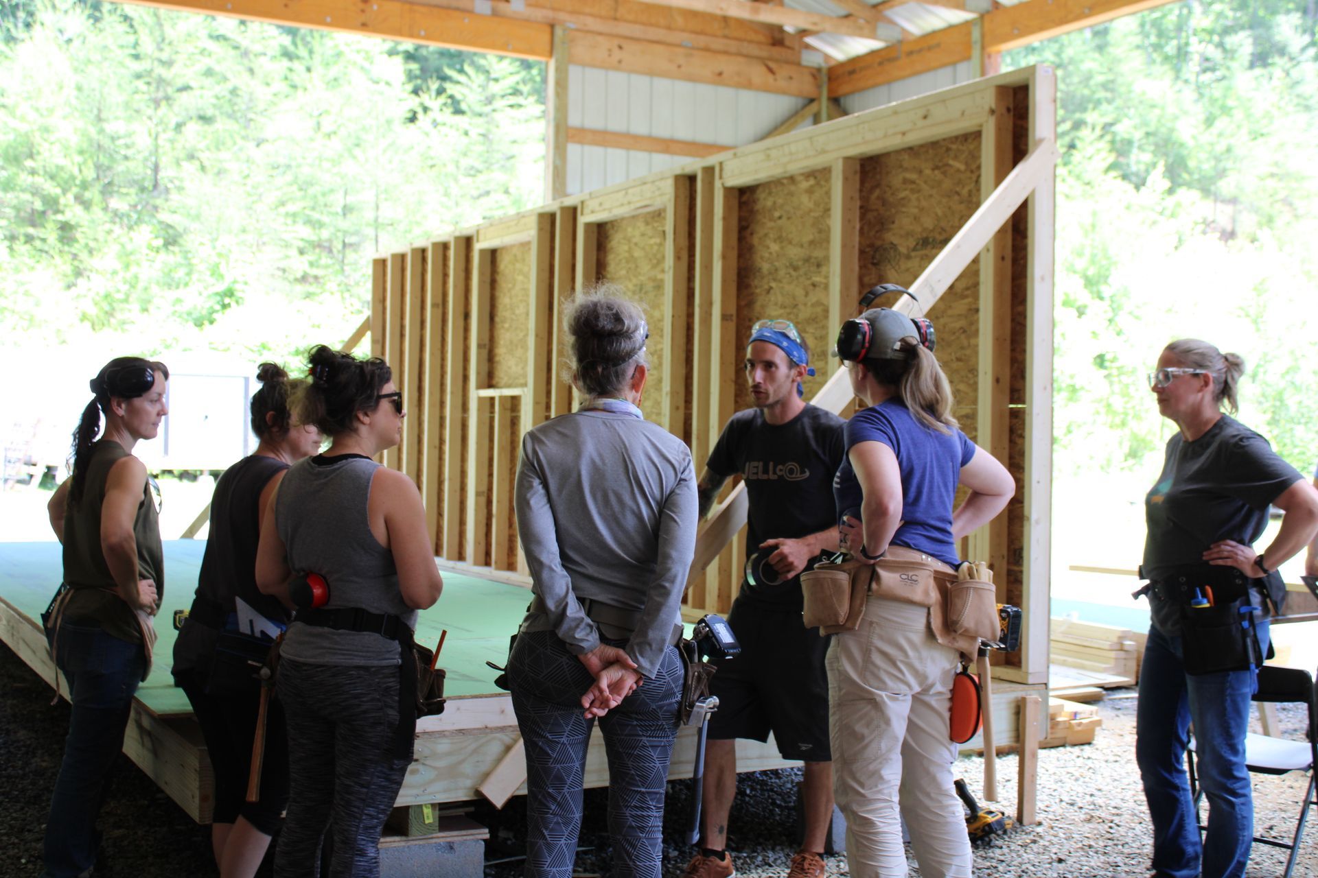 A group of people are standing in front of a building under construction.