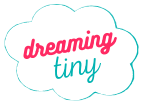 The logo for dreaming tiny is a cloud with the words dreaming tiny written inside of it.