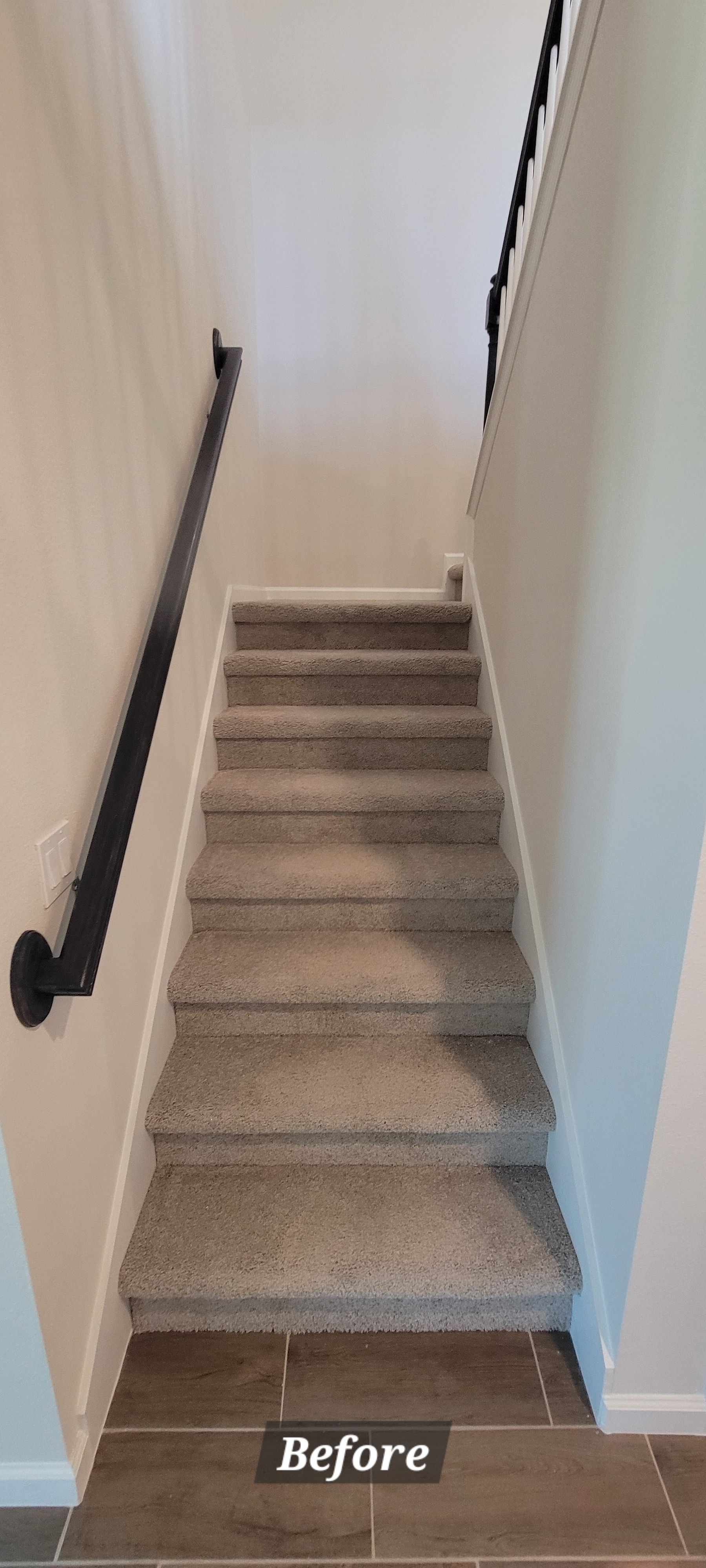 A picture of a staircase before being remodeled.