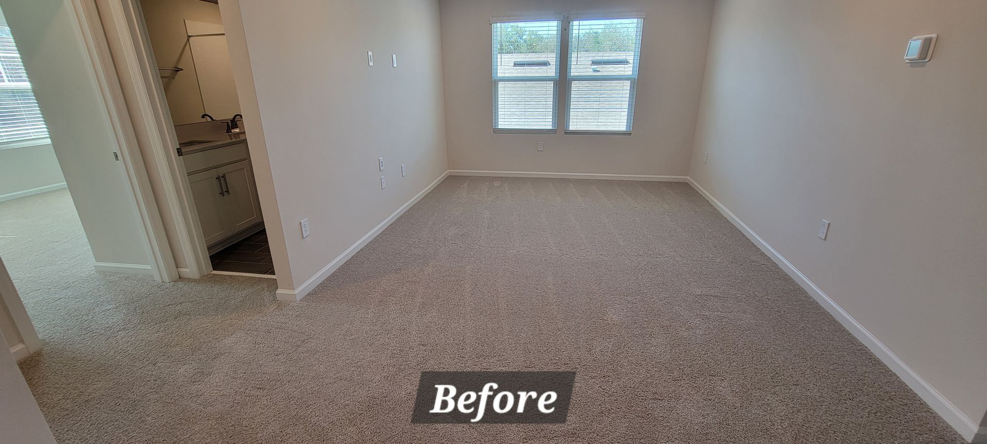 A before picture of a bedroom with a carpeted floor.