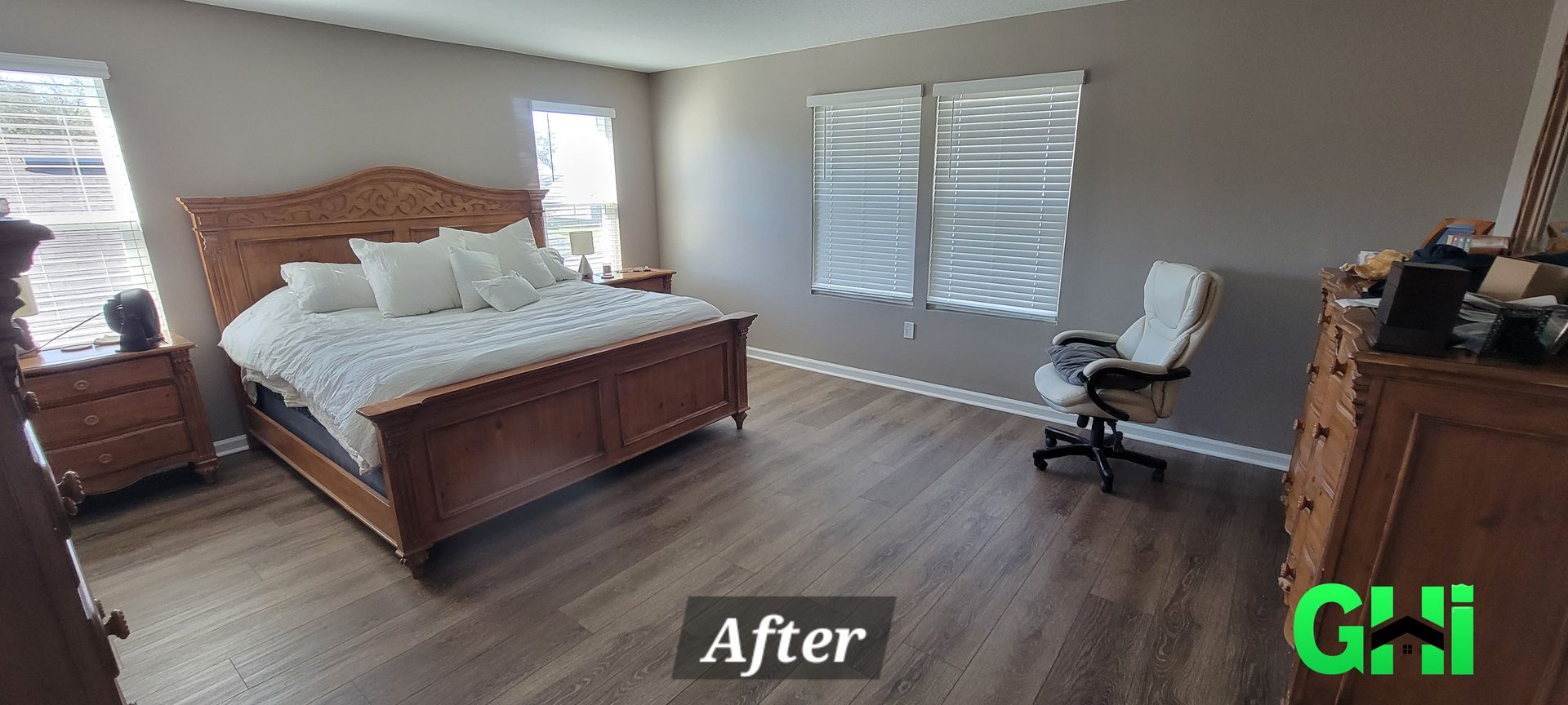 A bedroom with a bed , dresser , nightstand and chair.