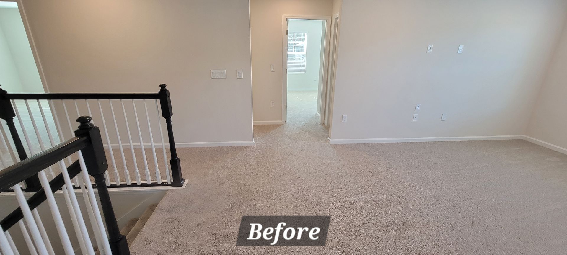 A before picture of a living room with a staircase and carpet.