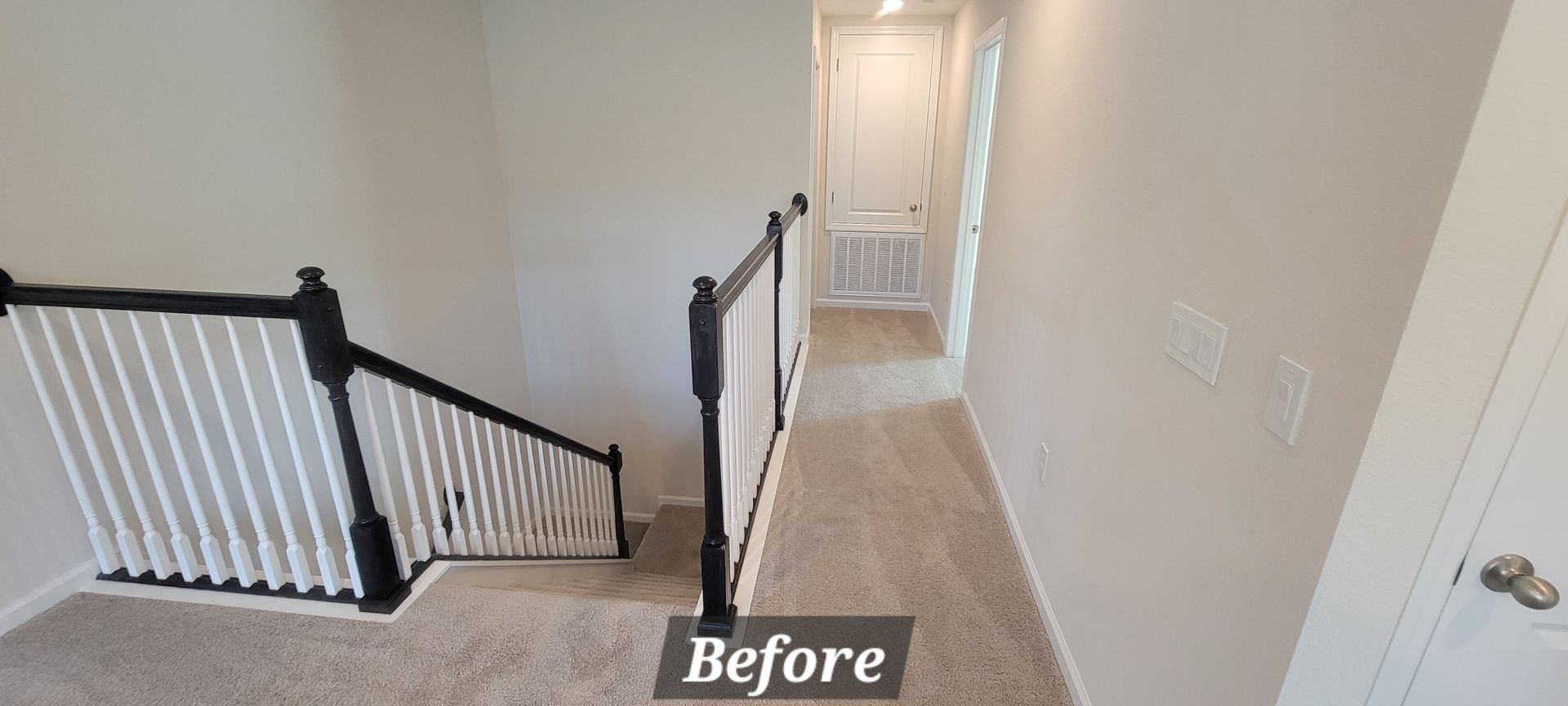 A before picture of a hallway with stairs and a railing.