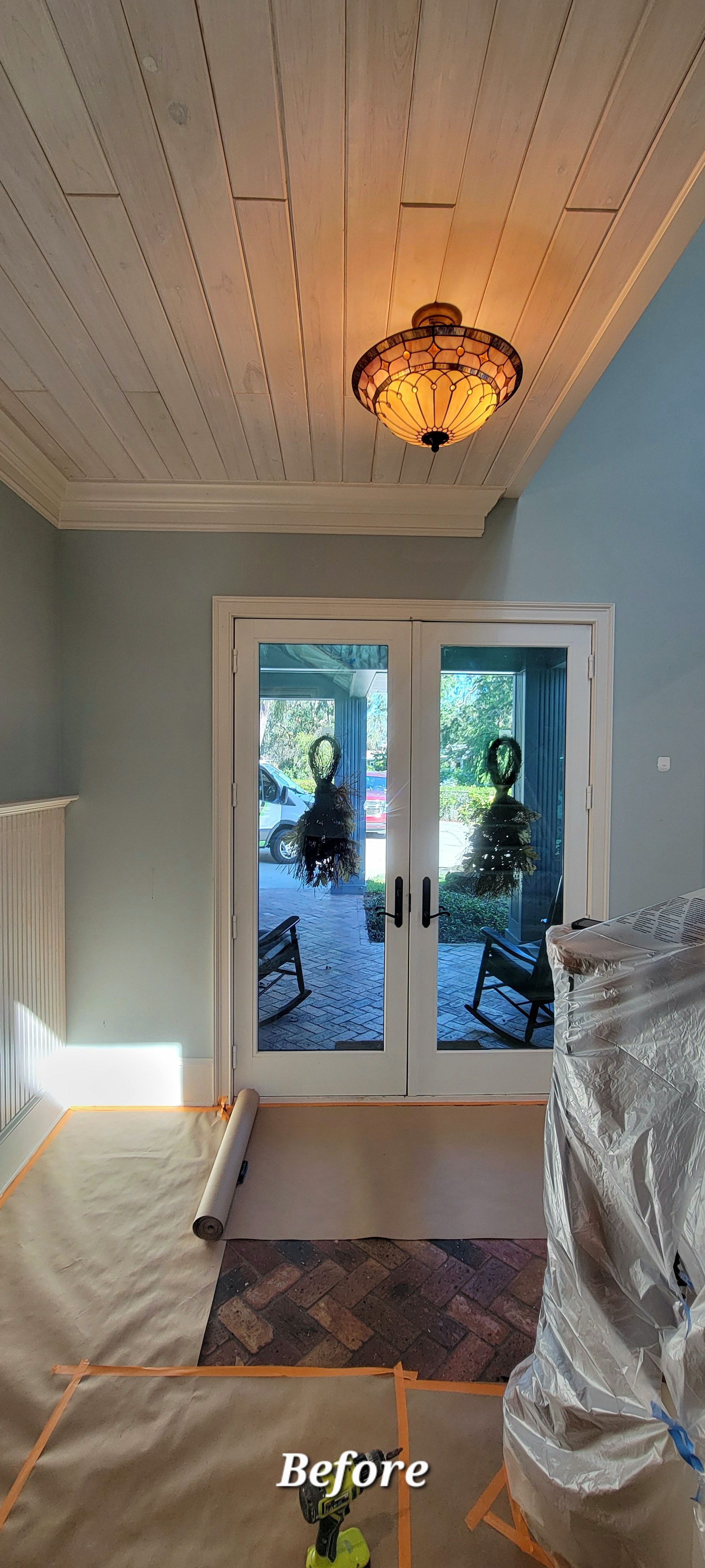 A room with sliding glass doors and a ceiling light.