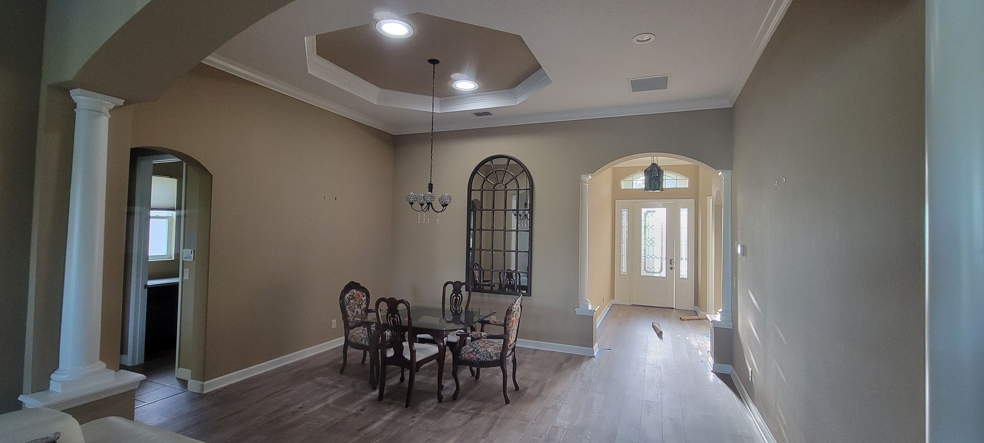 An empty dining room with a table and chairs in a house.